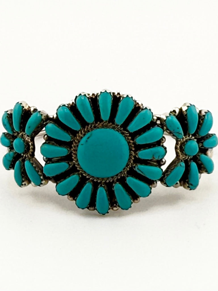 Turquoise bracelet with bronze accents on a white background