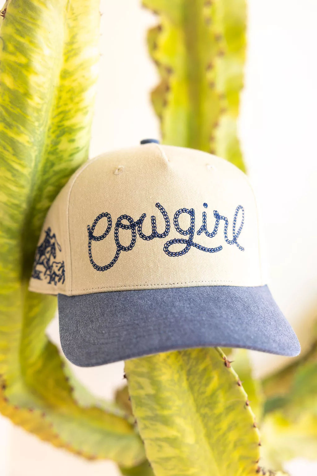 Beige and blue cap with 'Cowgirl' embroidery on a cactus background