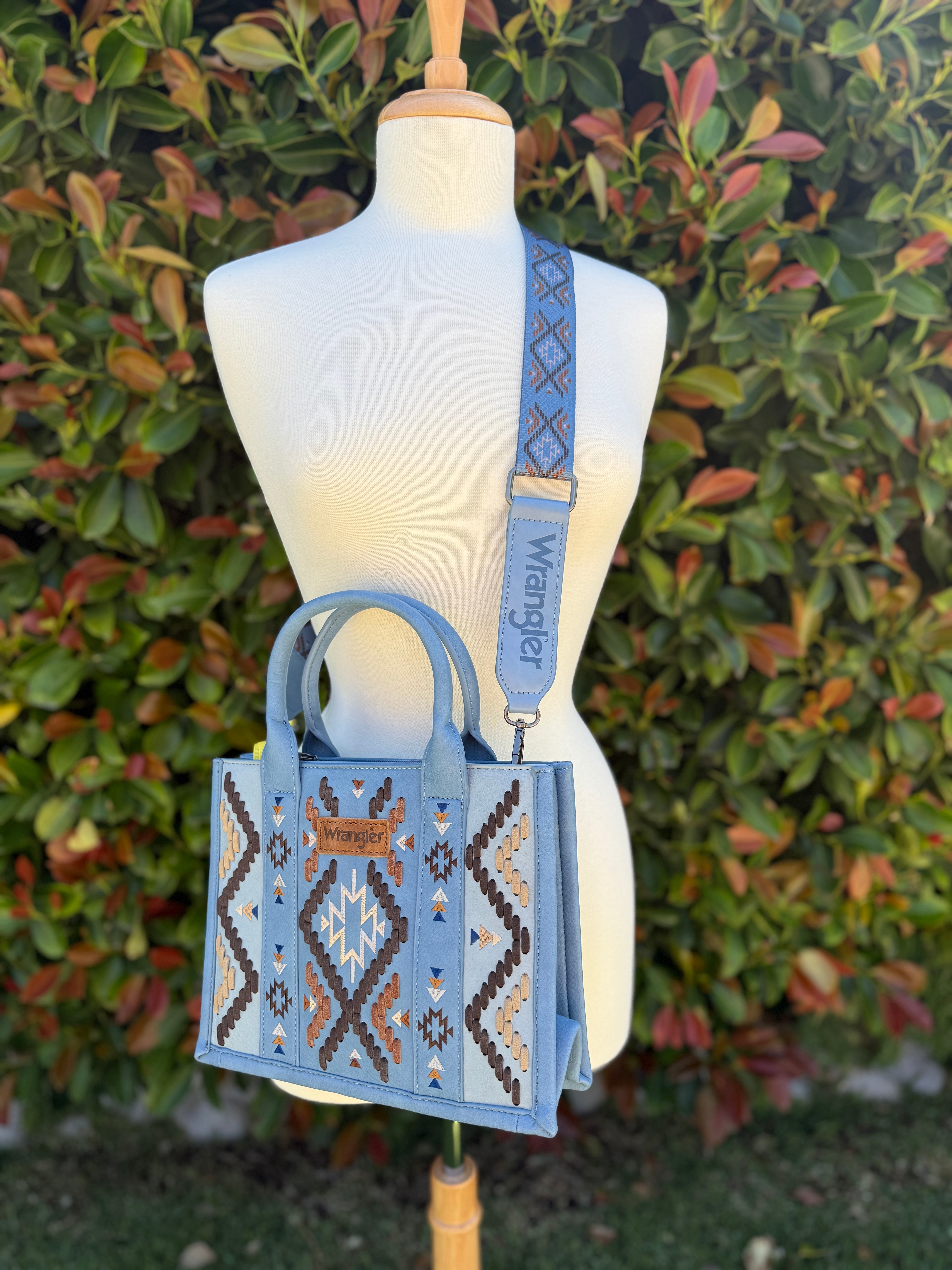 Aztec embroidered tote/crossbody bag in blue color displayed on a mannequin.