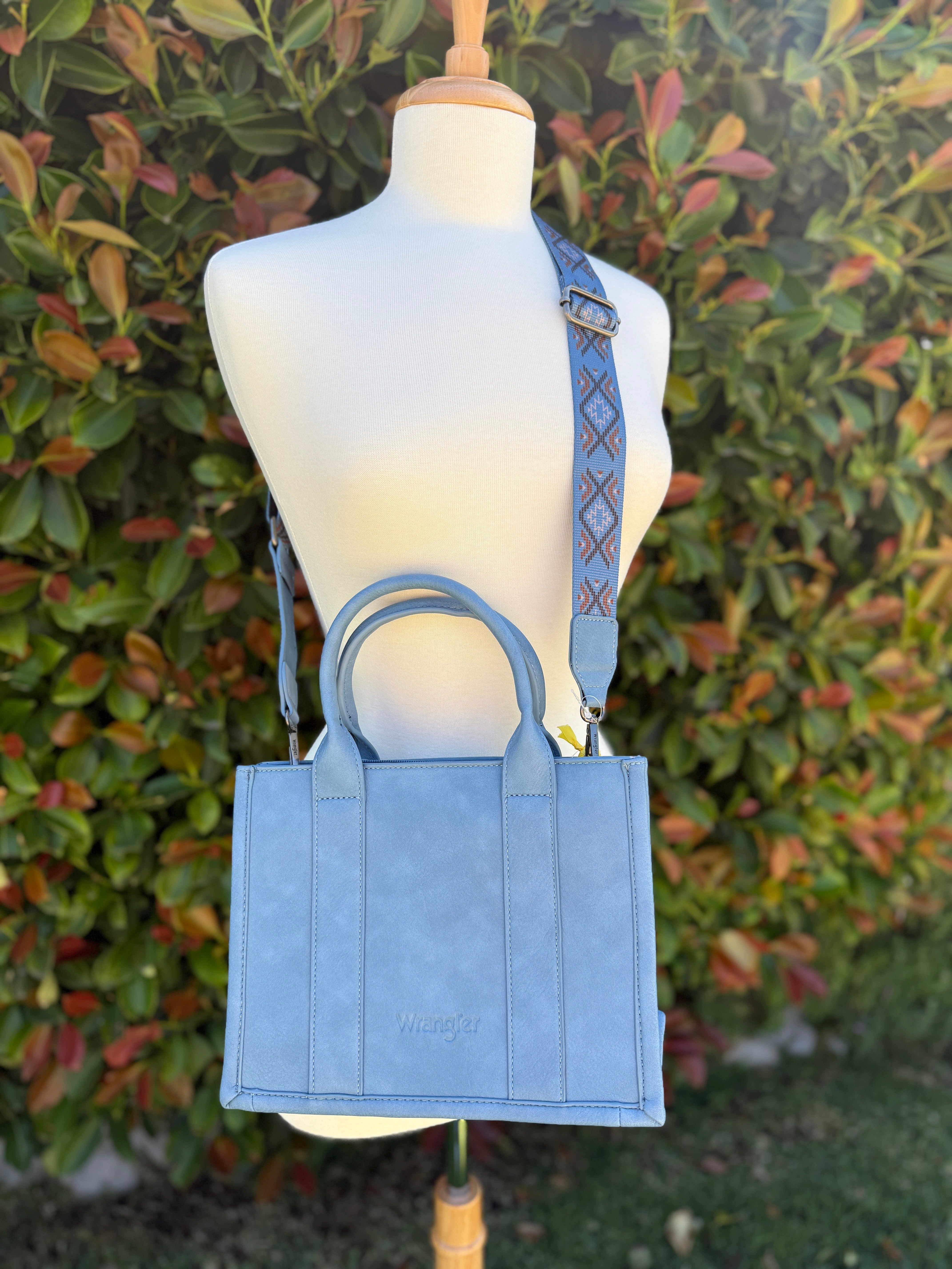 Aztec embroidered tote/crossbody bag in blue color displayed on a mannequin.