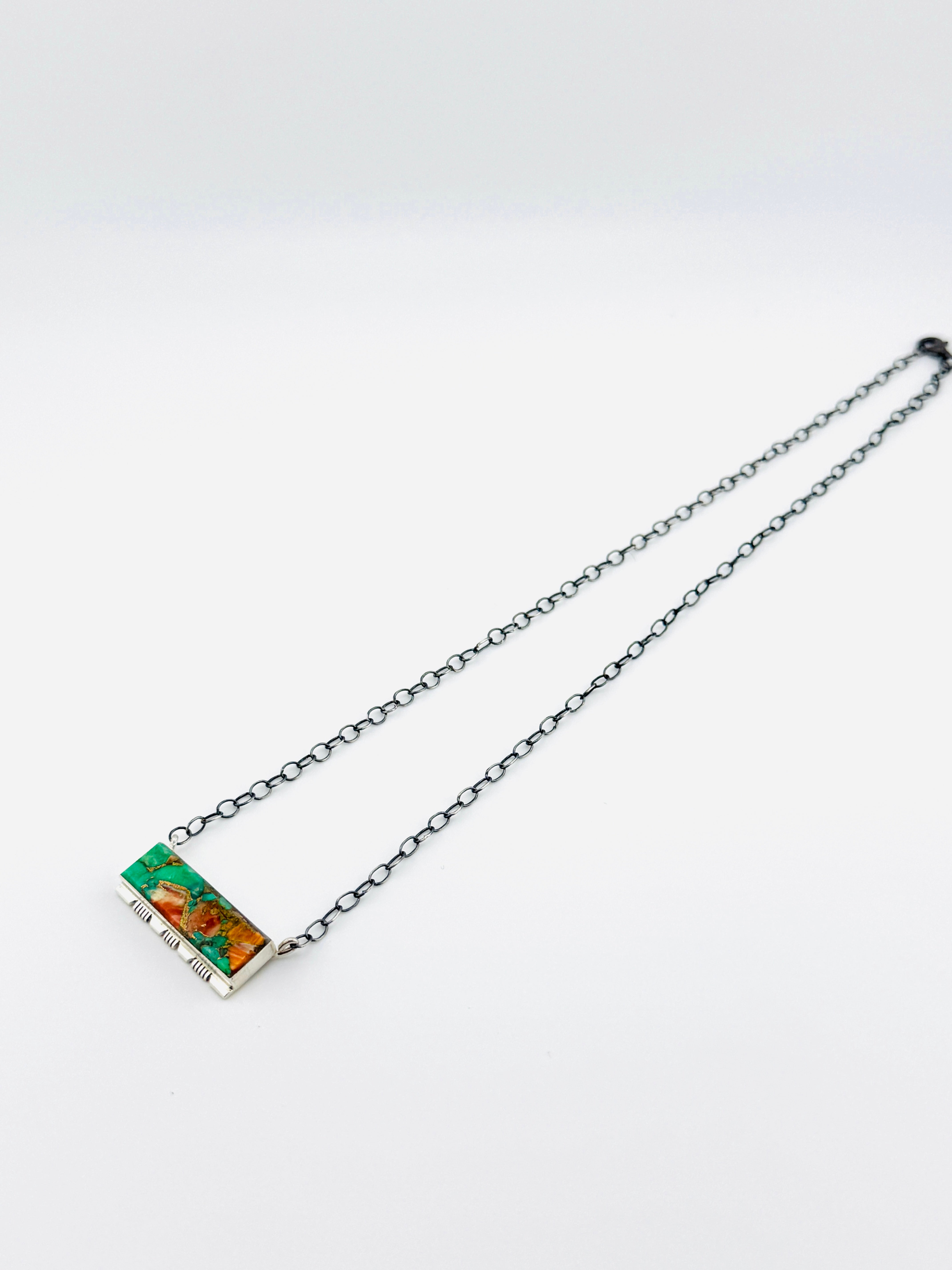 Necklace with a rectangular pendant on a white background