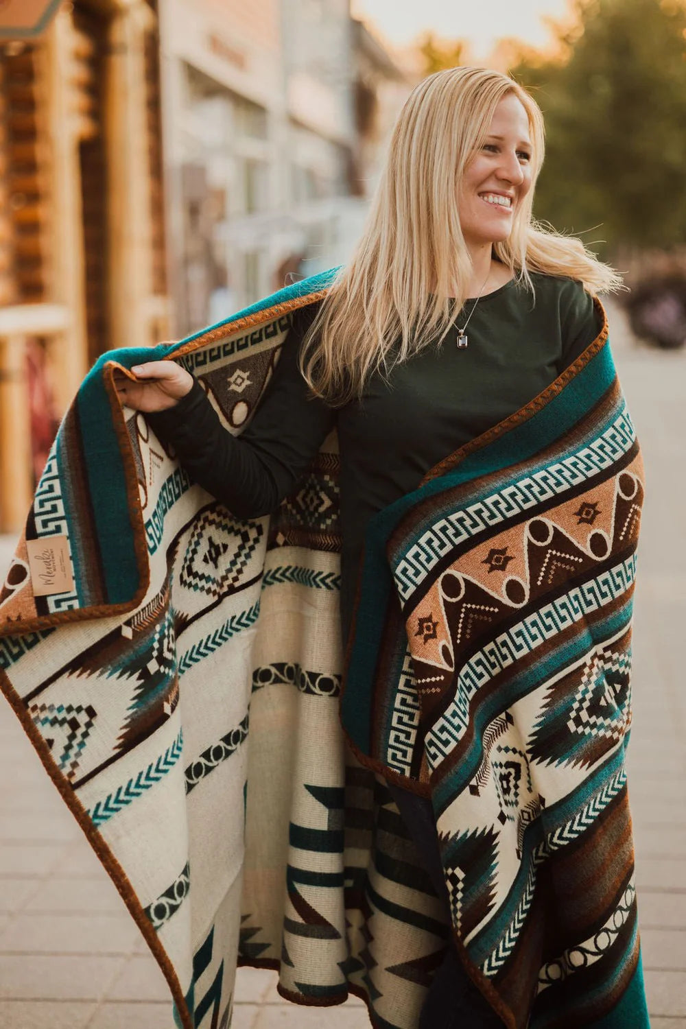 Woman wearing a patterned blanket outdoors