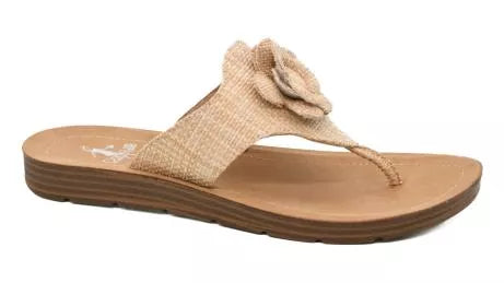 Beige sandal with a flower detail on a white background