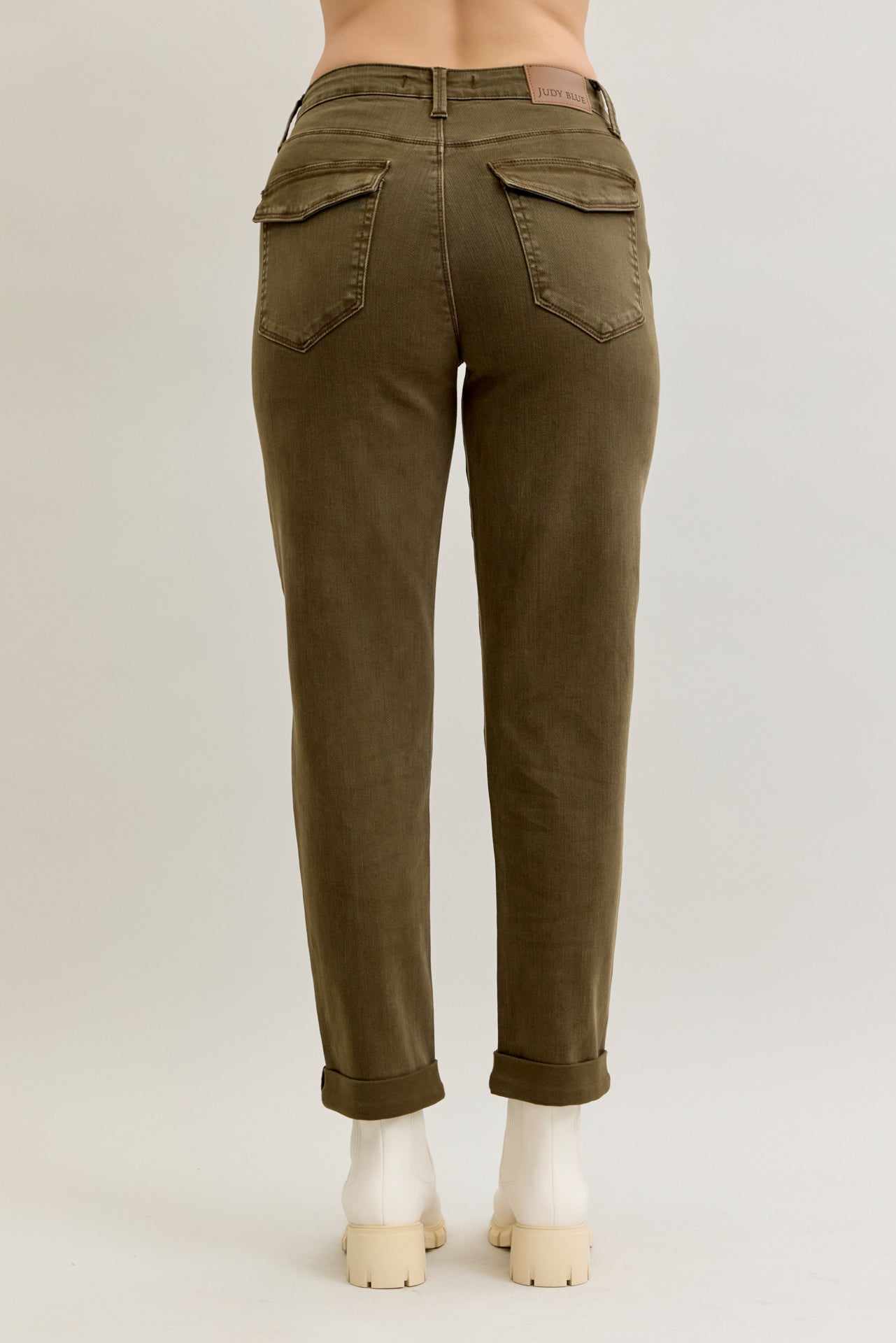 Olive green pants on a mannequin against a plain background