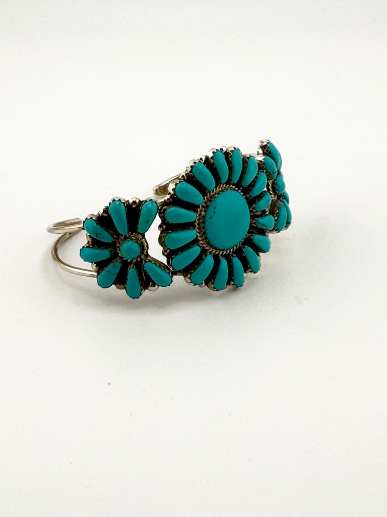Turquoise flower-shaped earrings on a white background