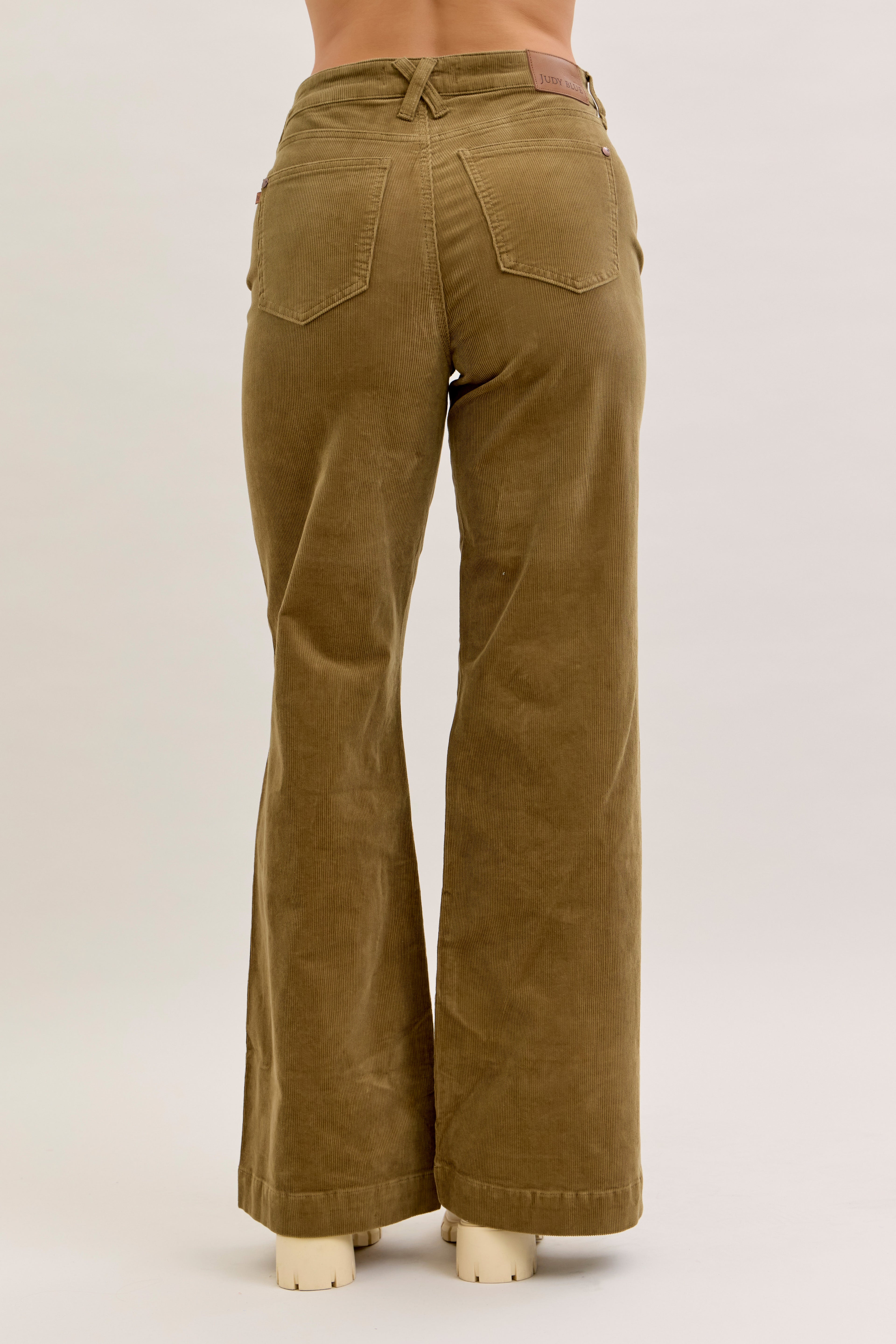 Brown corduroy pants on a white background