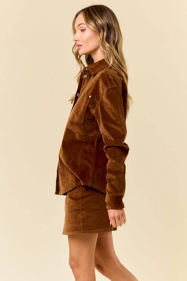 Woman wearing a brown corduroy shirt and skirt set on a beige background