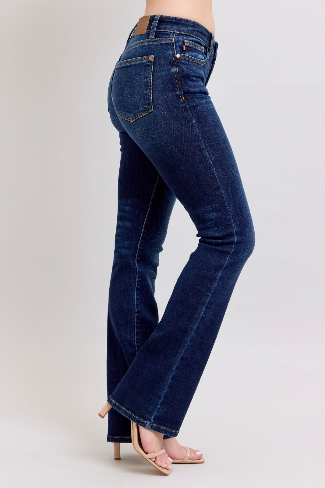 Blue jeans worn by a person on a white background