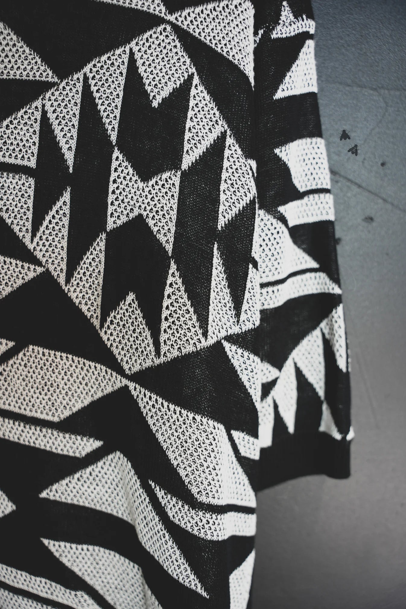 Close-up of a black and white geometric patterned top