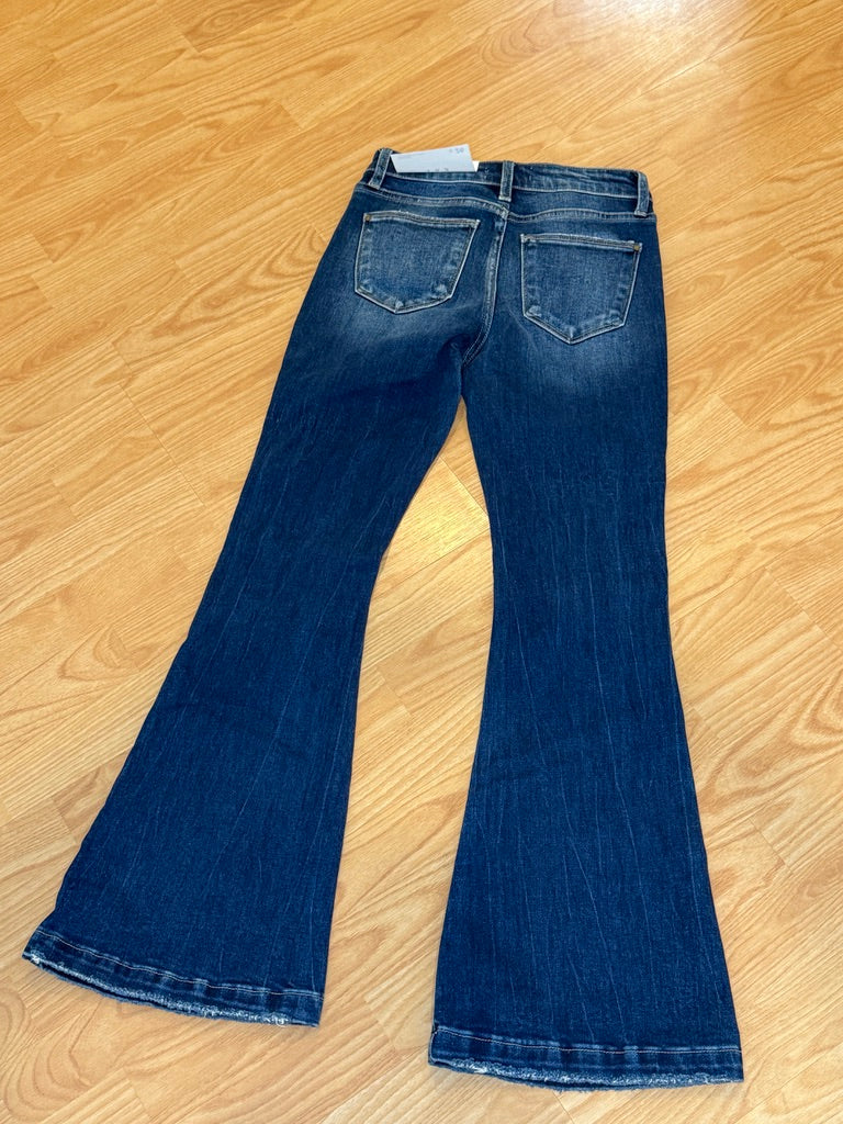 Pair of blue jeans on a wooden floor