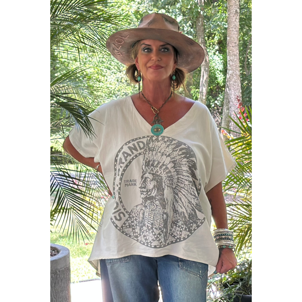 Woman wearing a white t-shirt with a graphic design outdoors