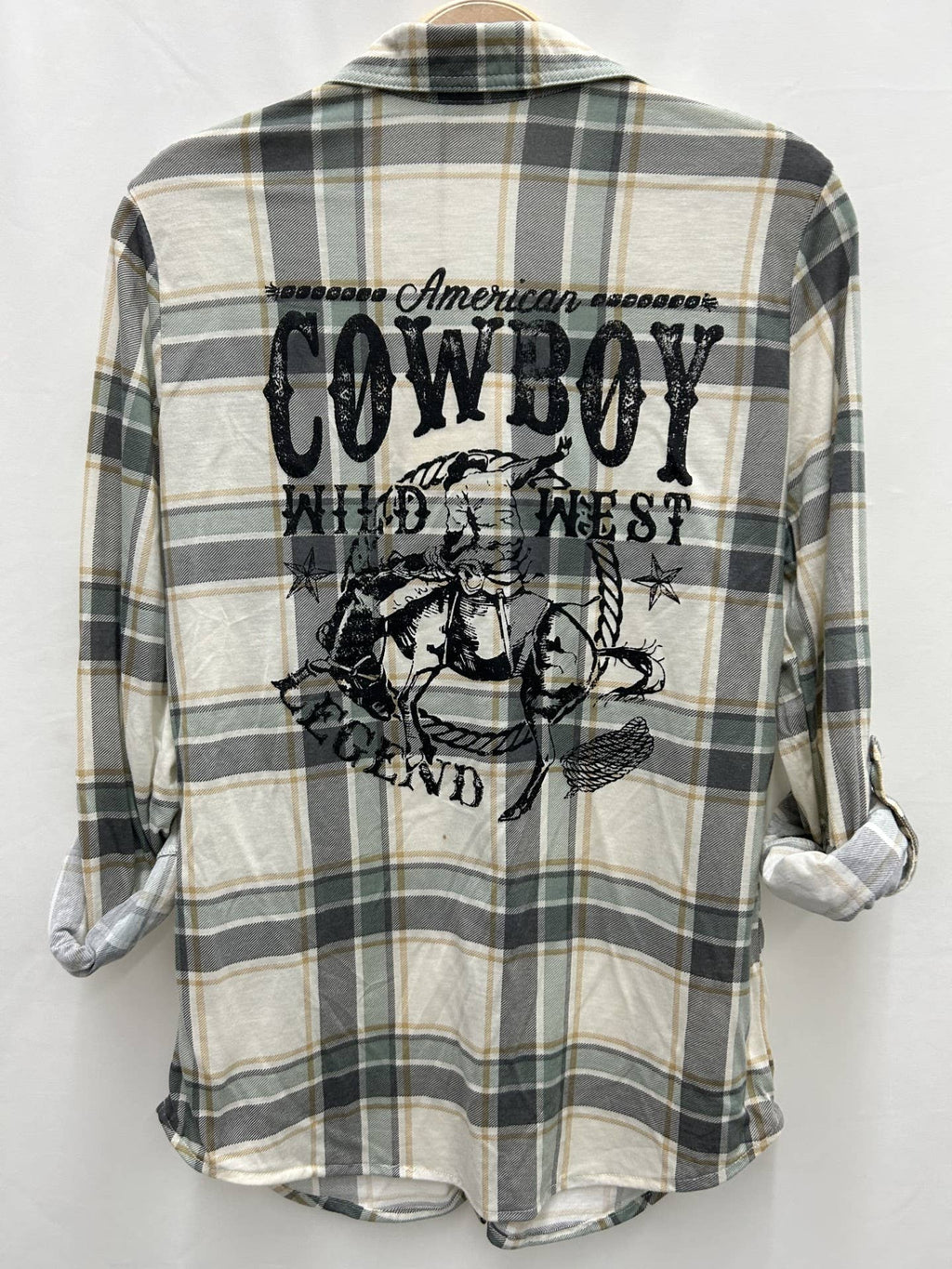 Plaid shirt with cowboy graphic and text on a white background