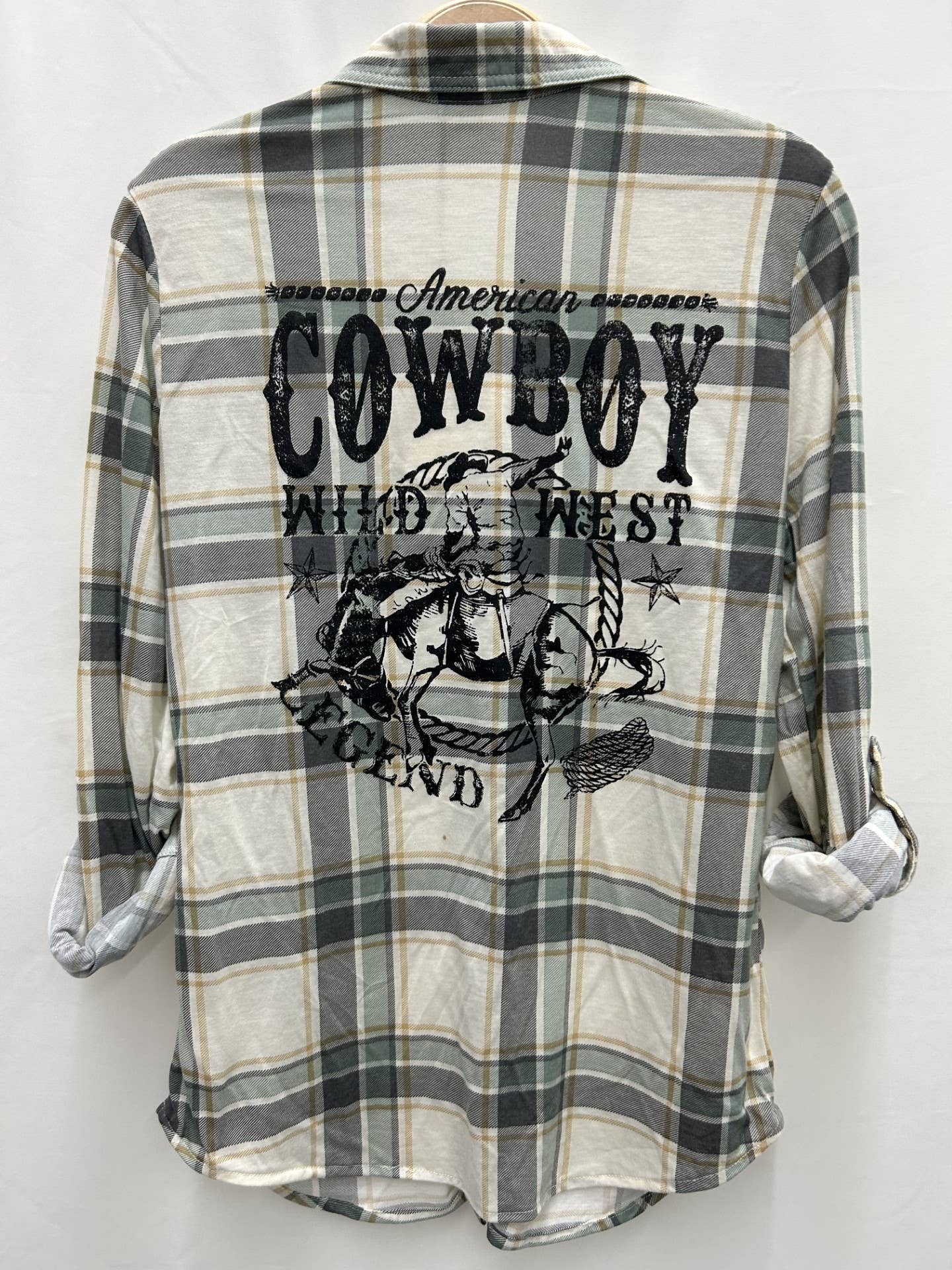 Plaid shirt with cowboy graphic and text on a white background