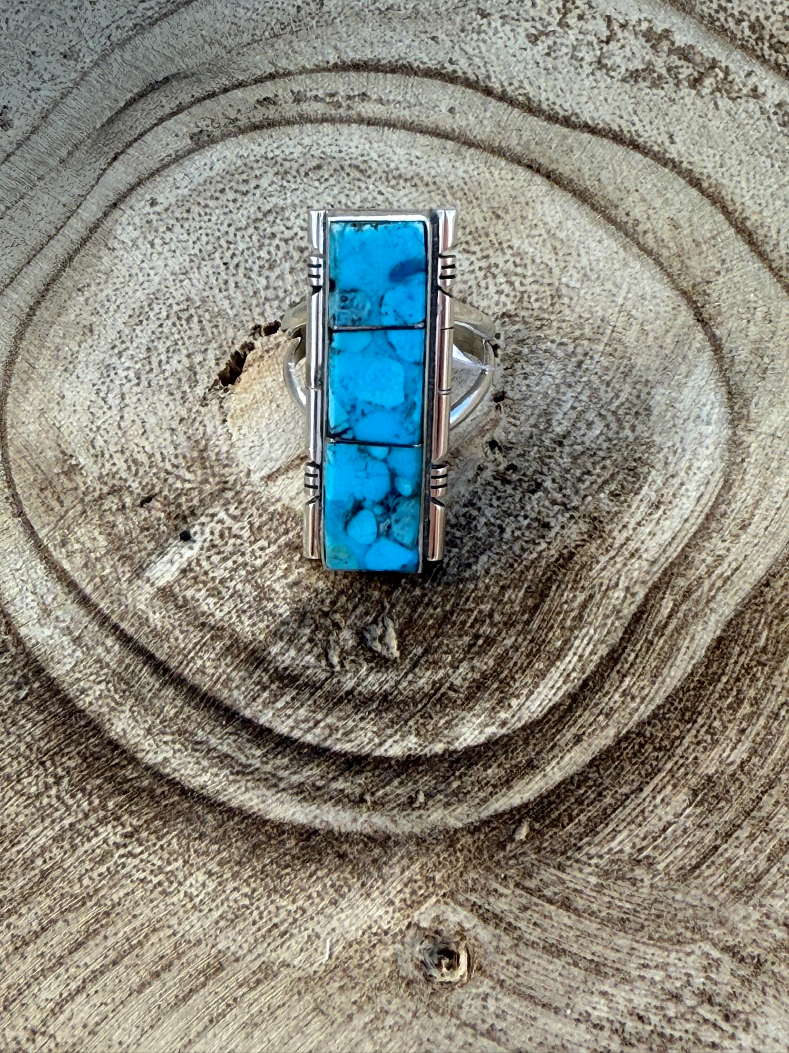 Turquoise stone ring on a wooden surface