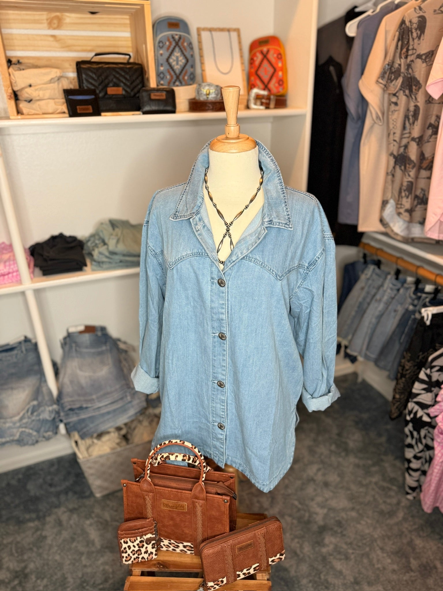 Denim jacket on a mannequin in a clothing store.