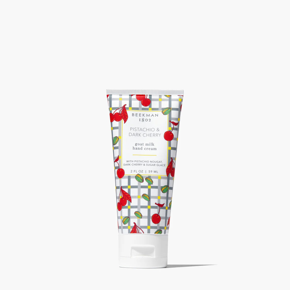 Hand cream tube with cherry design on a white background