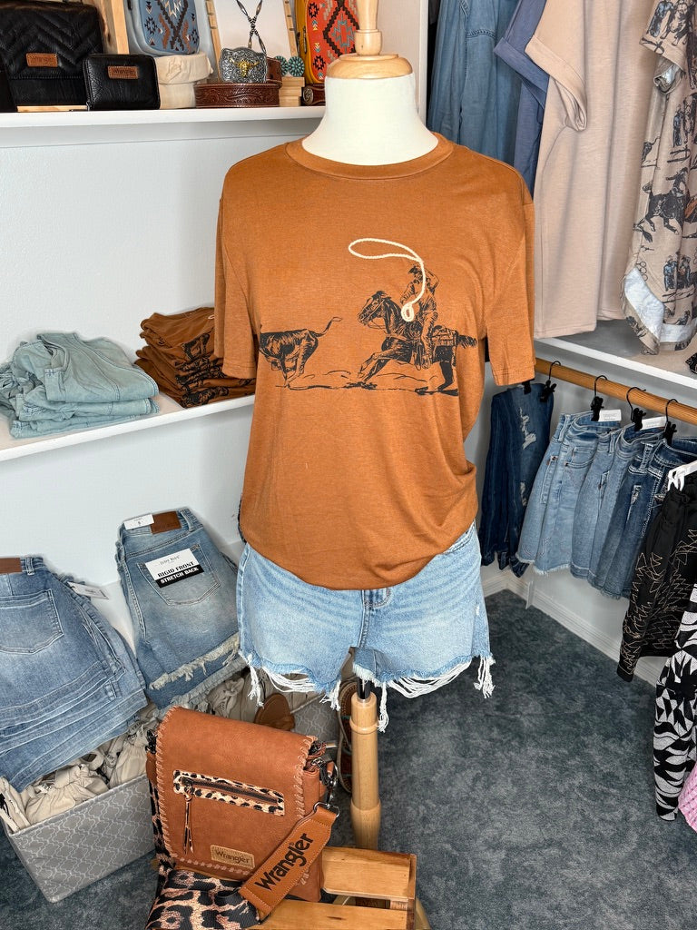 Mannequin wearing a brown t-shirt with a graphic in a clothing store.
