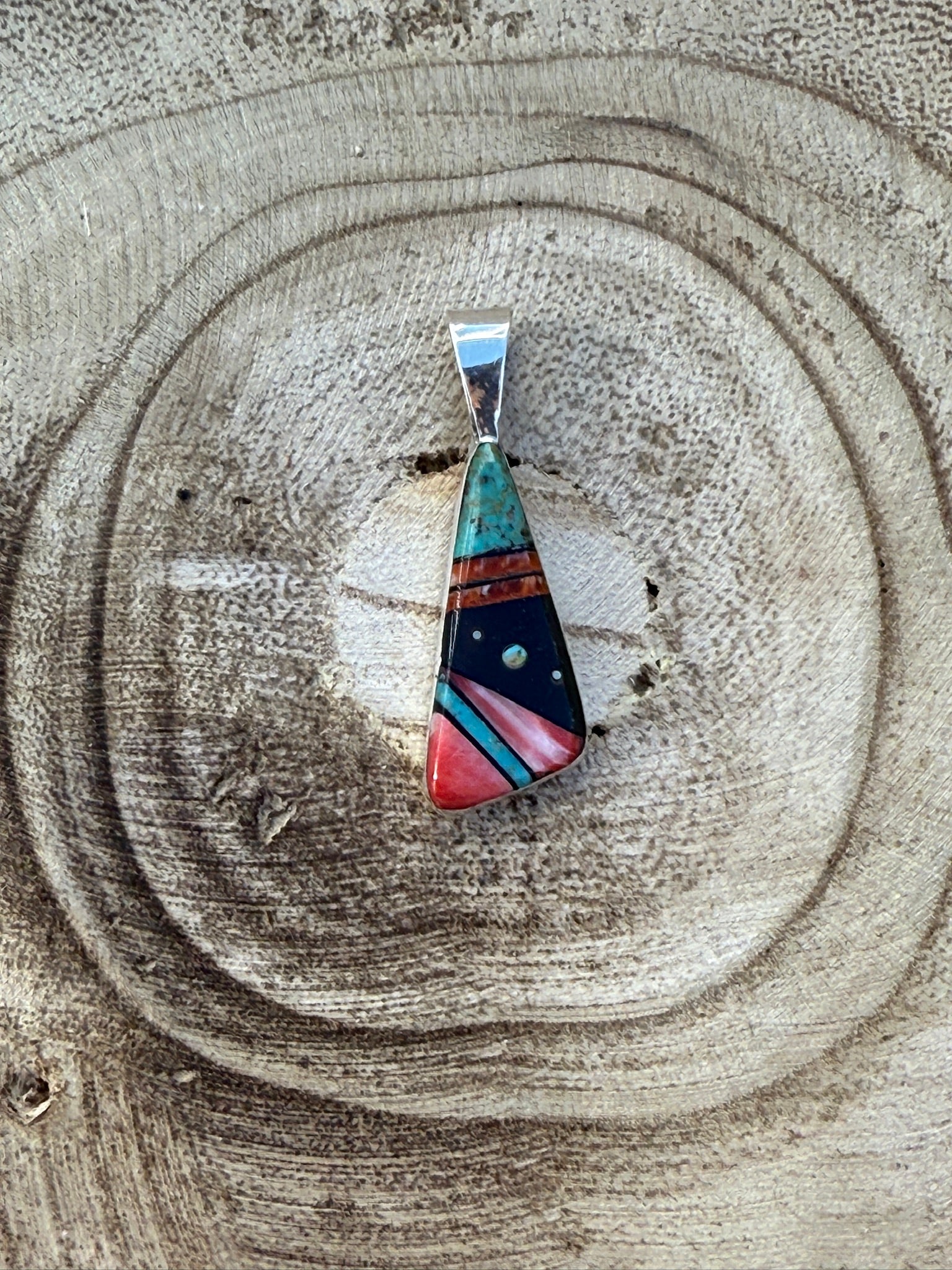 Multicolored pendant on a wooden surface