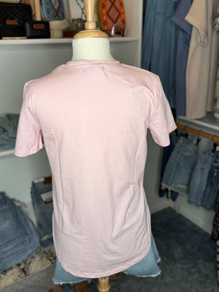 Pink t-shirt on a mannequin in a clothing store.