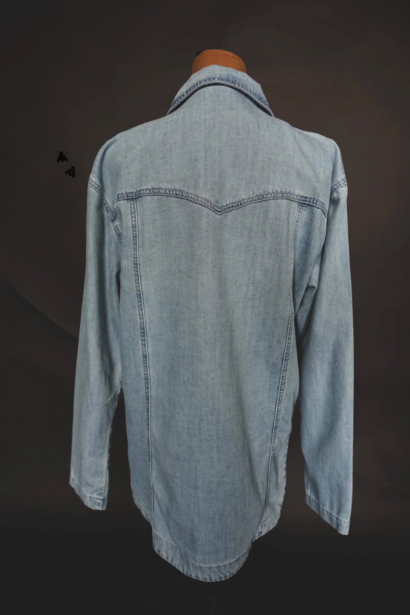 Light blue denim shirt on a dark background