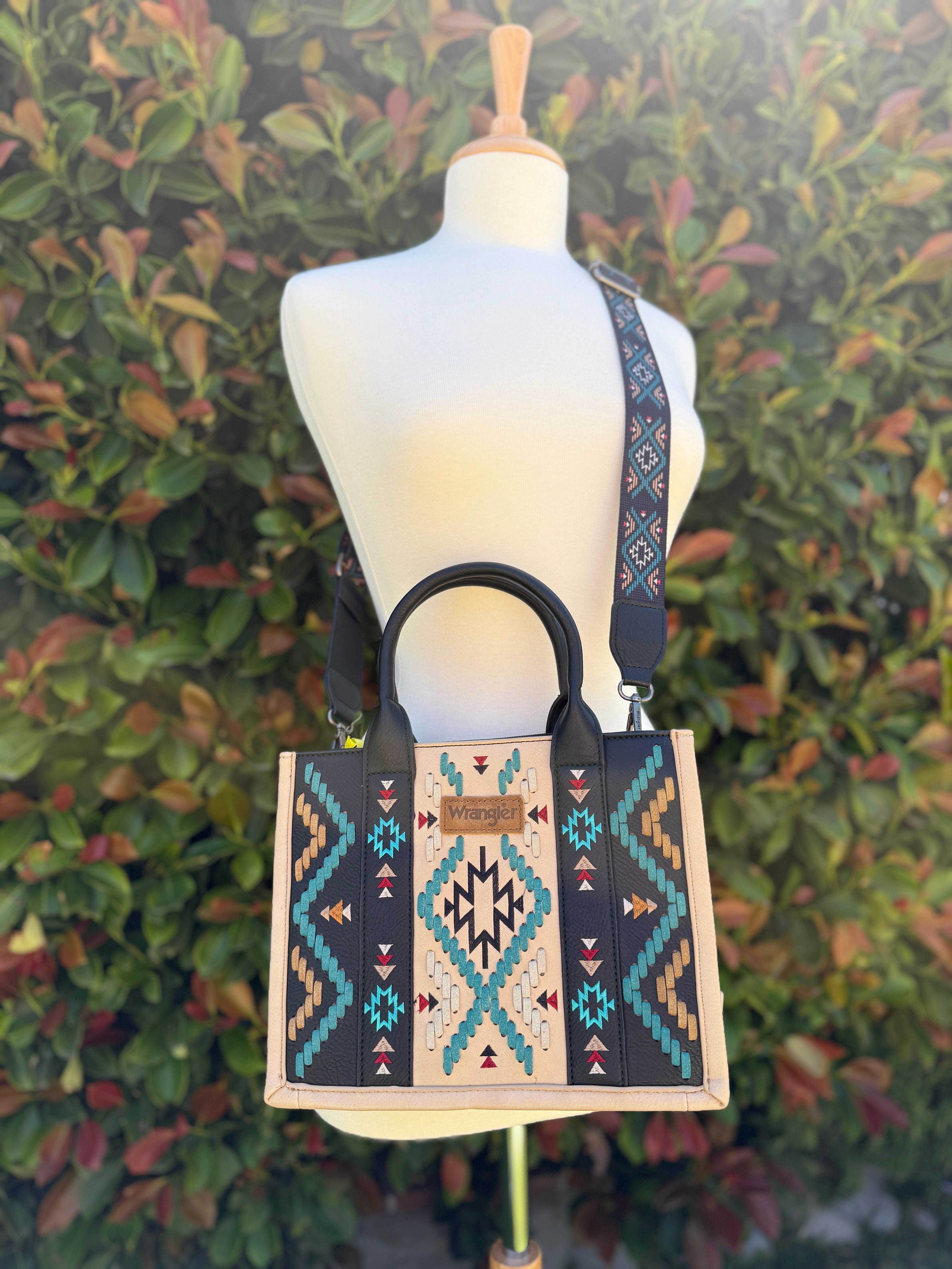 Wrangler  crossbody with handles. Tan trim bag with black, turquoise and aztec print details