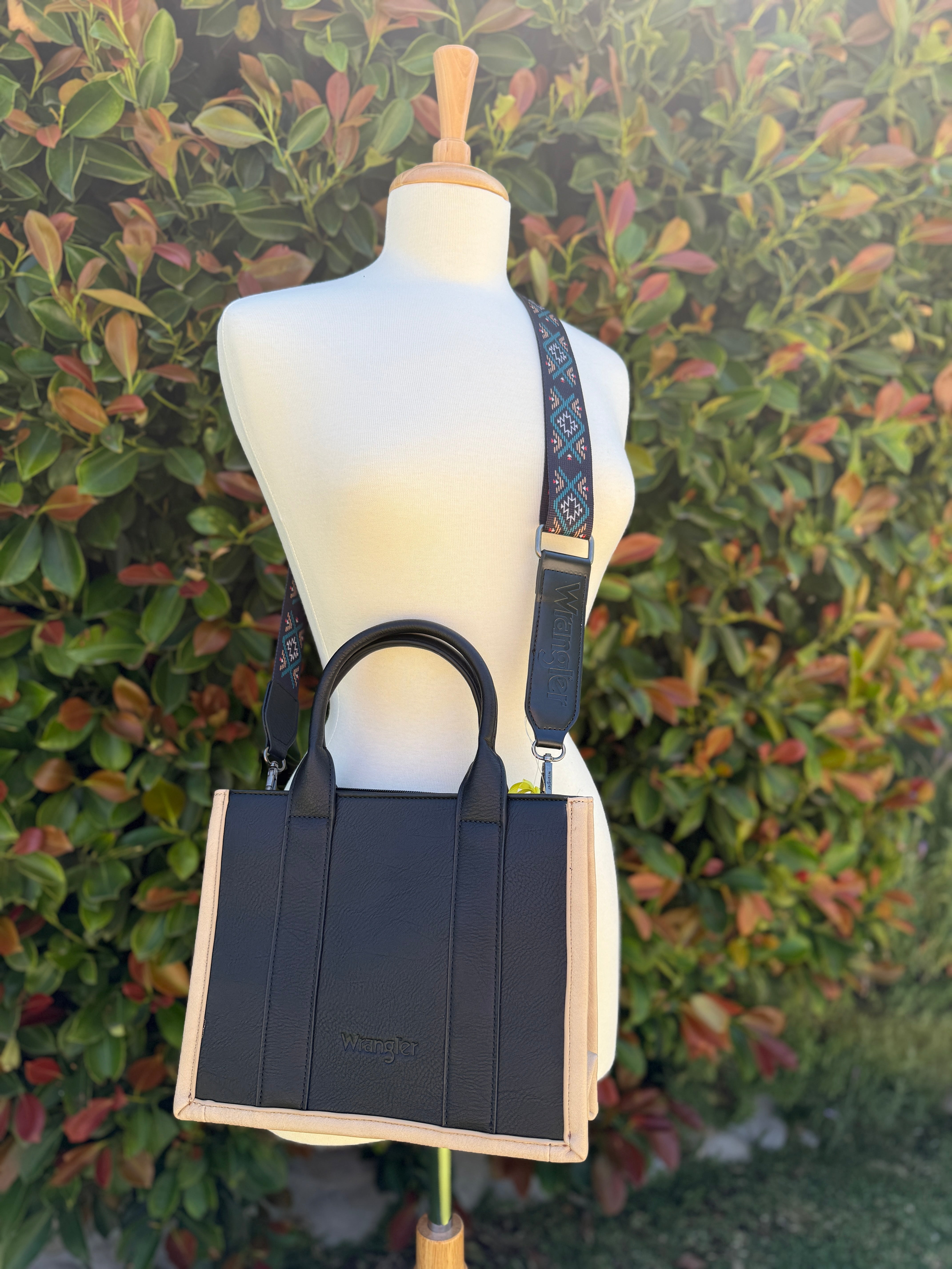 Wrangler  crossbody with handles. Tan trim bag with black, turquoise and aztec print details
