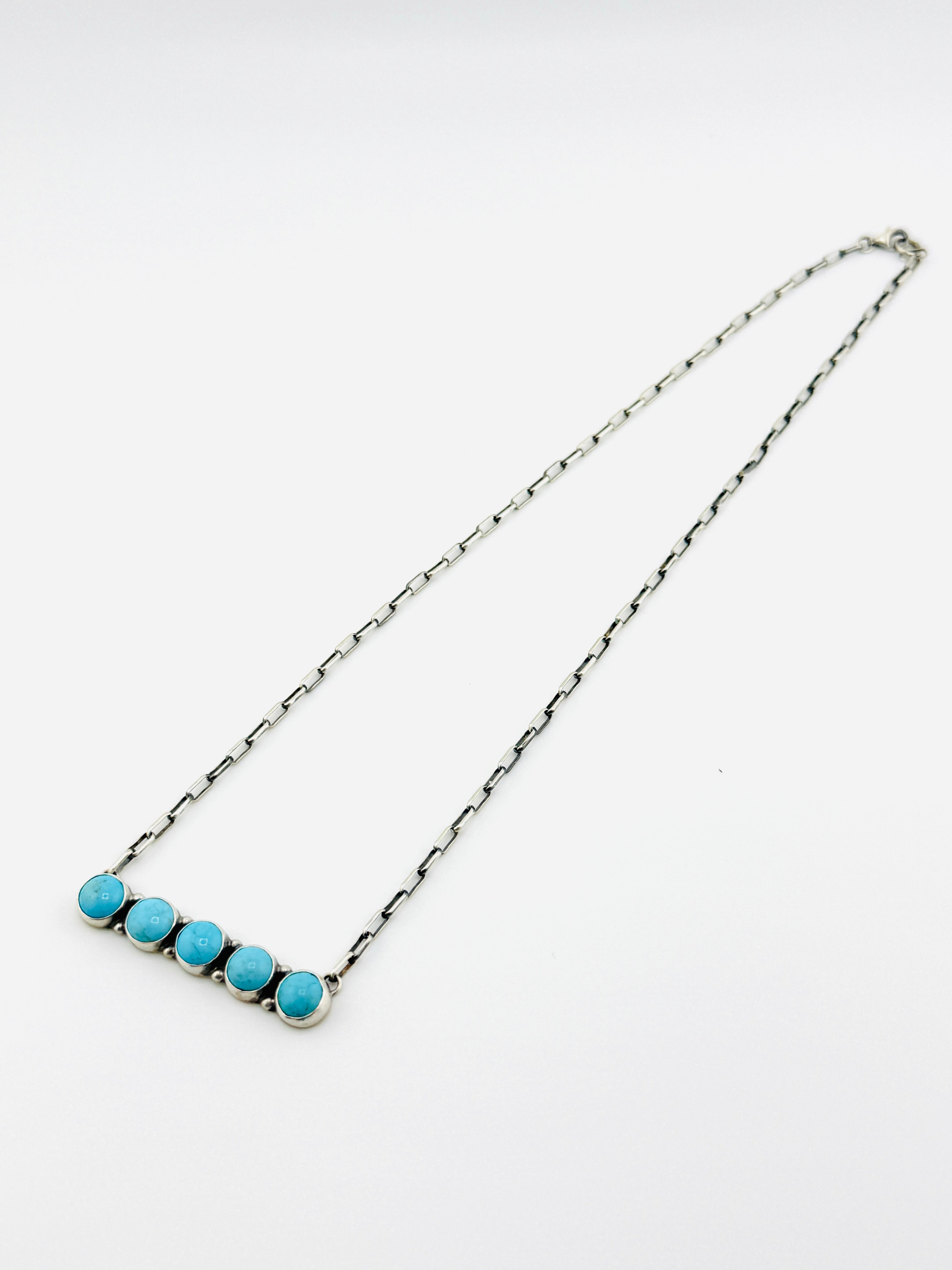 Necklace with blue beads on a white background
