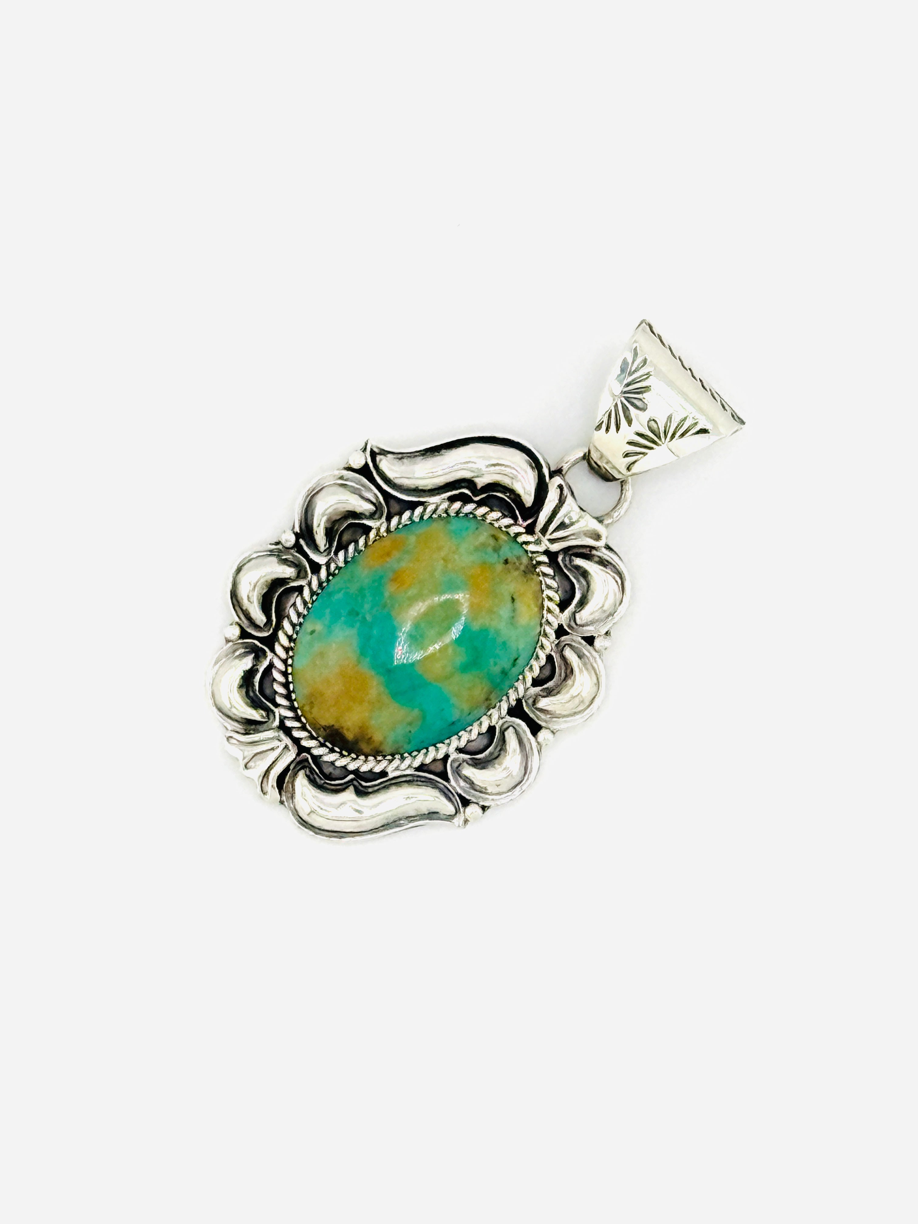 Silver pendant with a turquoise stone on a white background