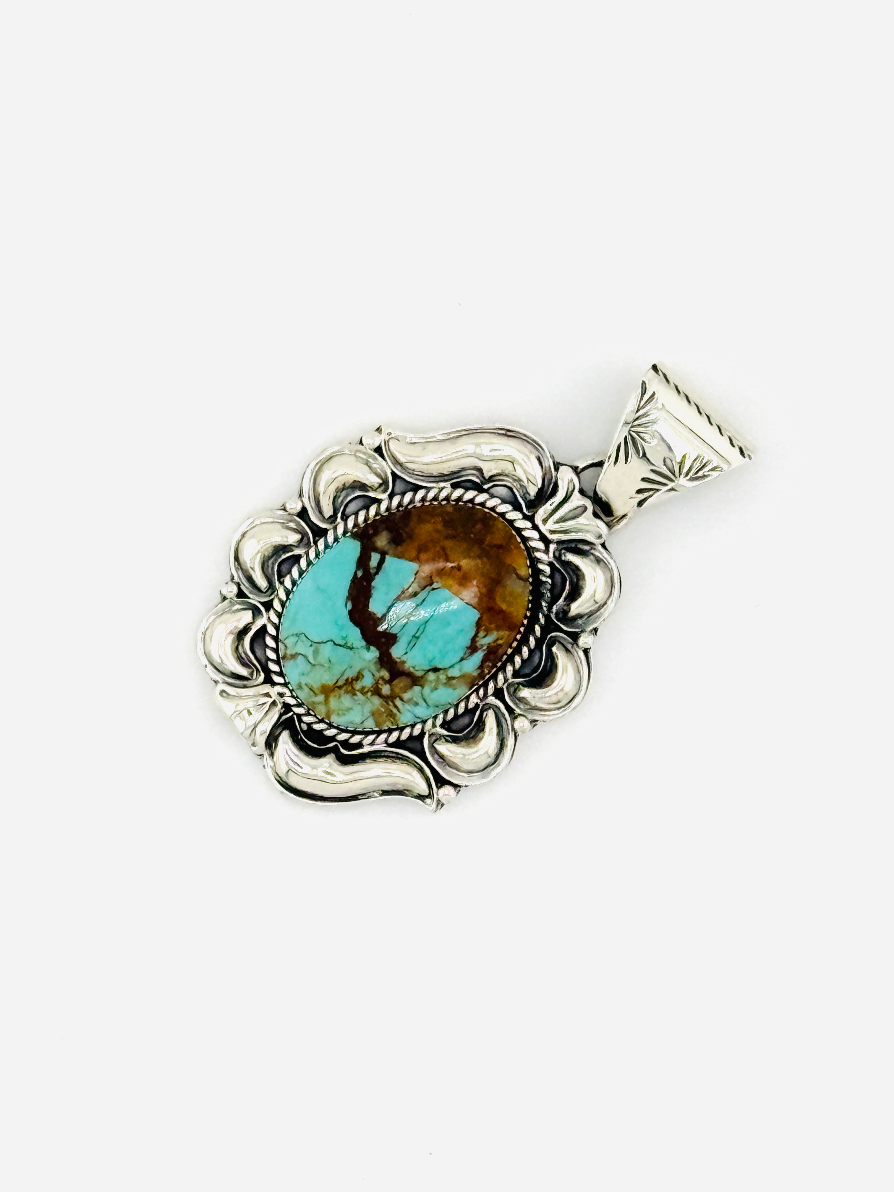 Turquoise stone pendant with silver decorative frame on a white background