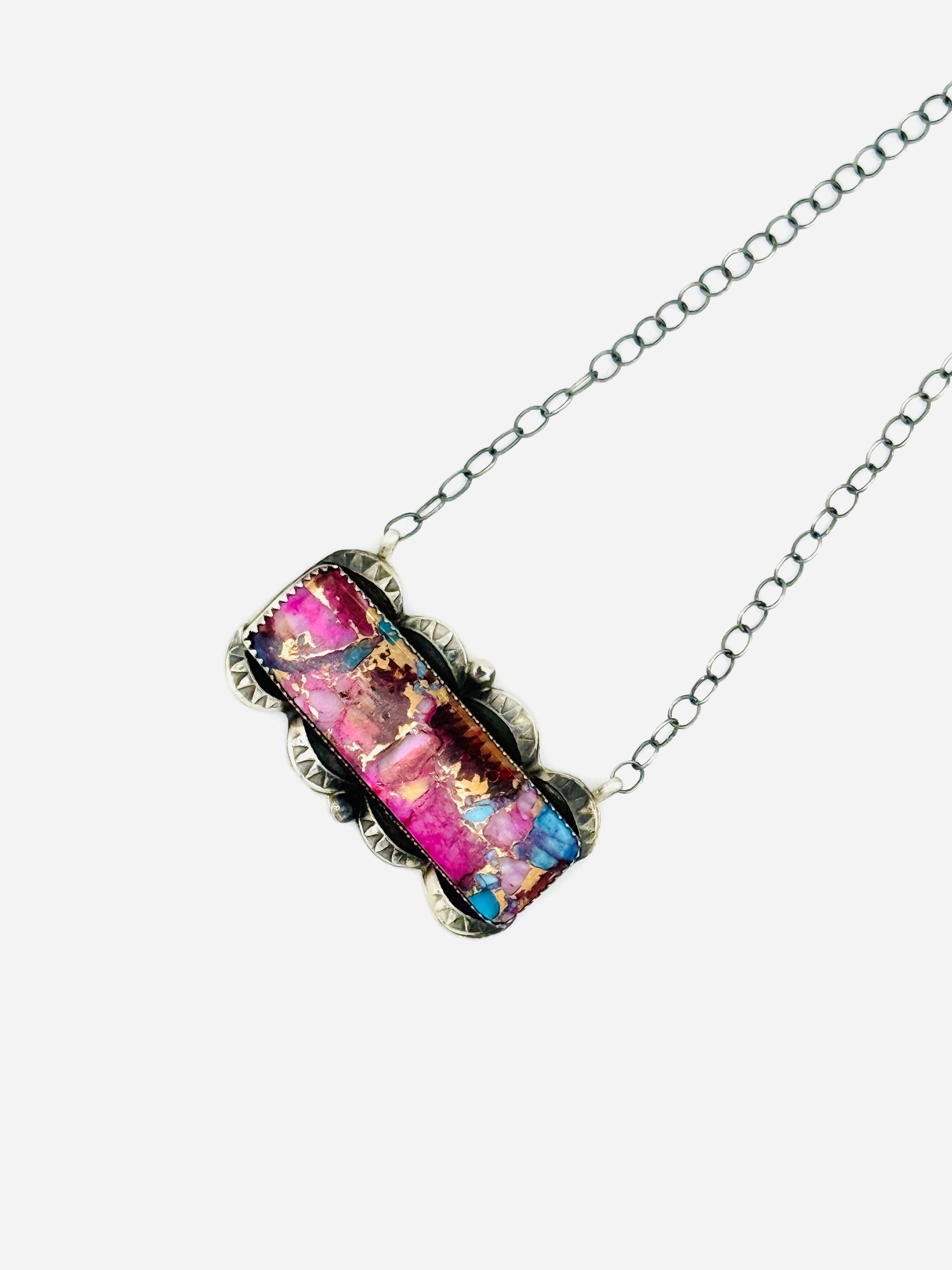 Necklace with a colorful pendant on a white background