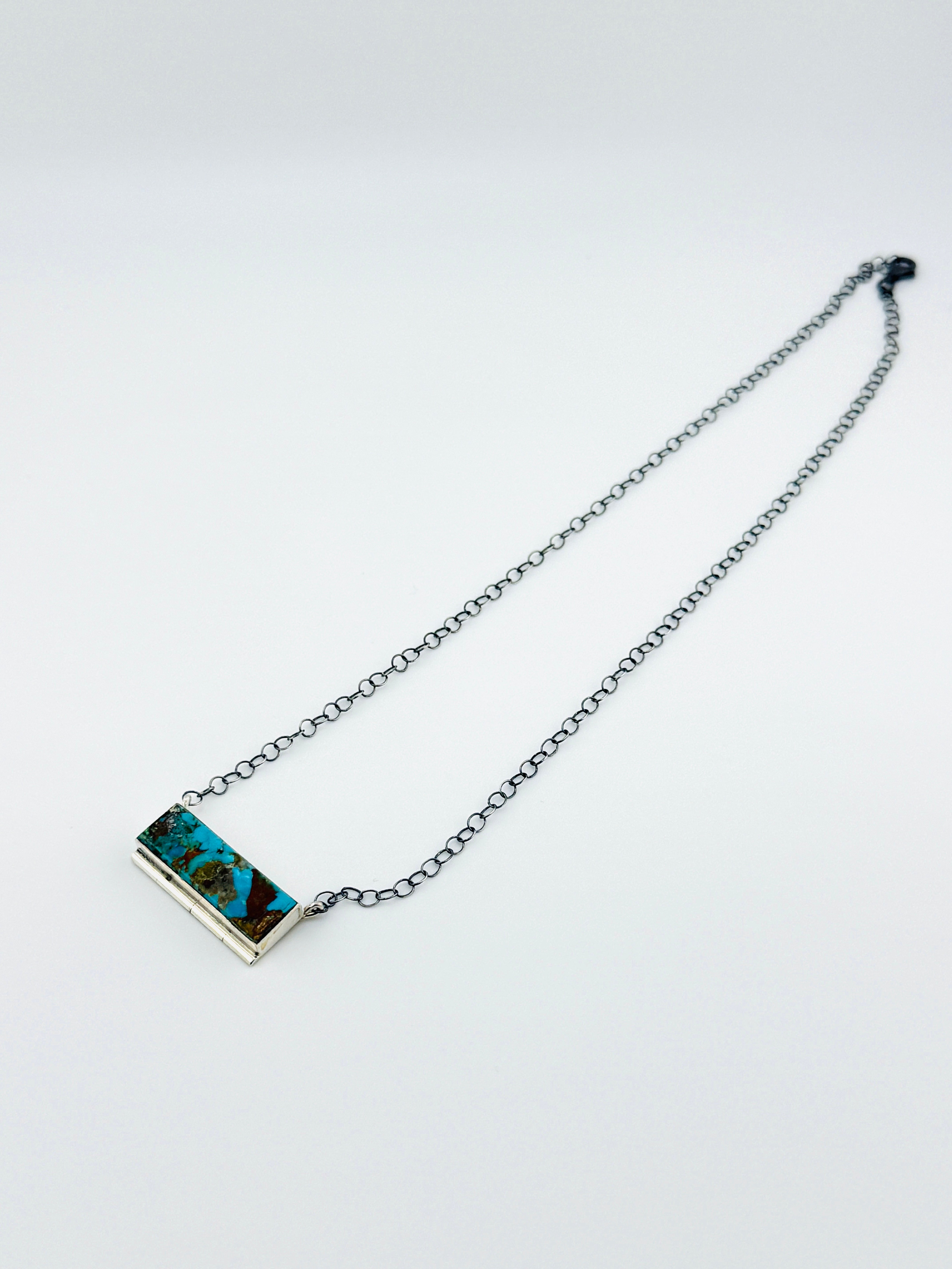 Necklace with a rectangular pendant on a light gray background