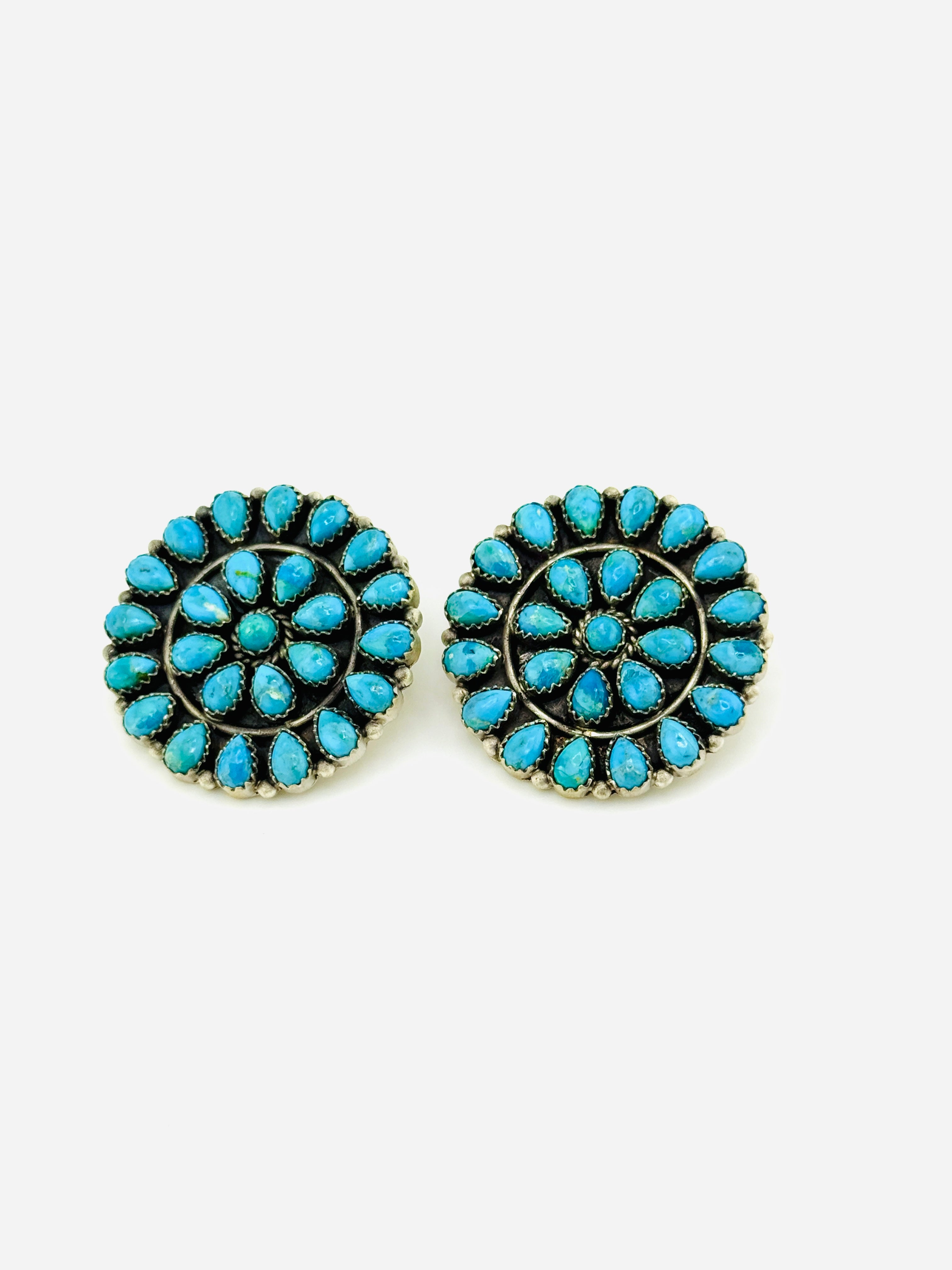 Pair of turquoise earrings on a white background