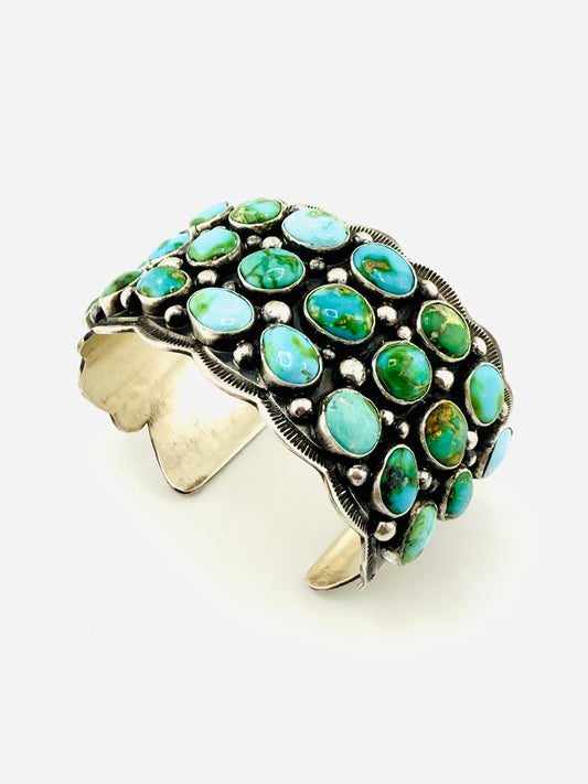 Turquoise stone ring with silver band on a white background