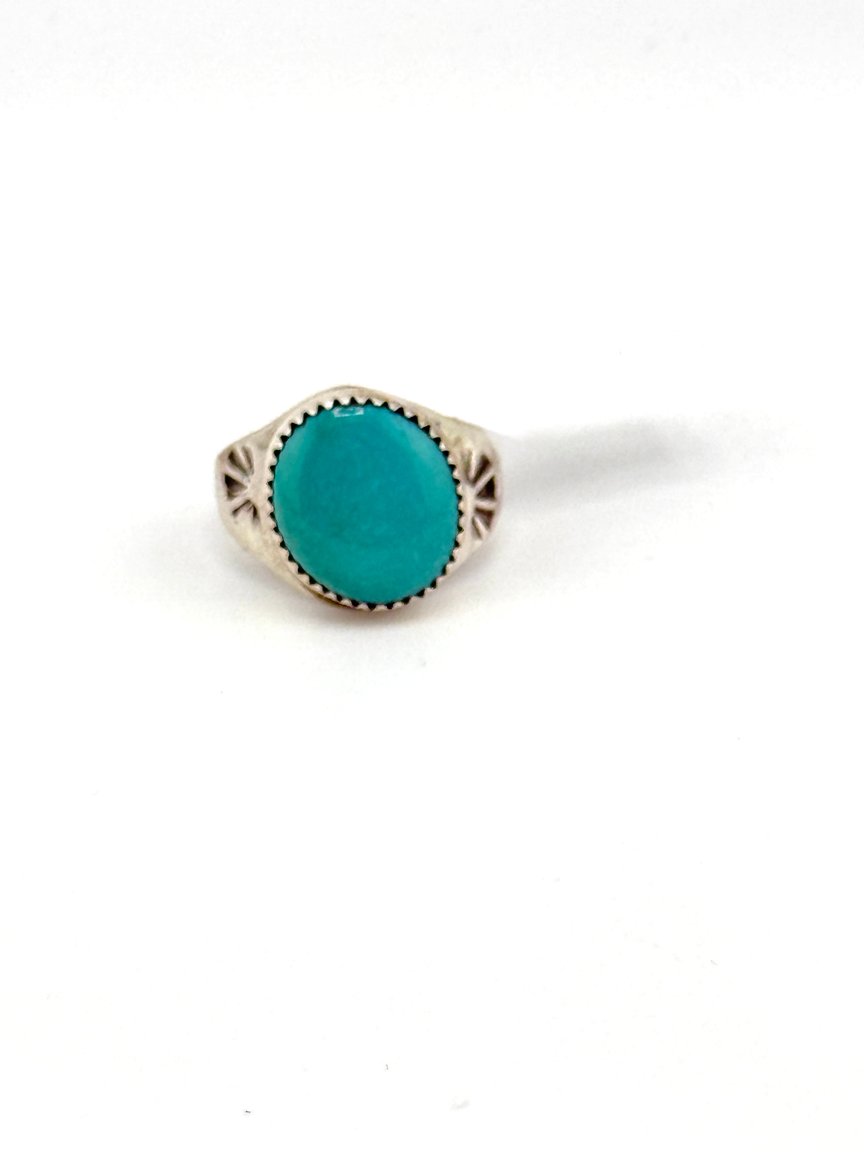 Turquoise ring with silver band on a white background