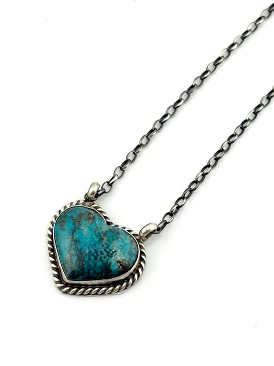 Necklace with a heart-shaped turquoise pendant on a white background