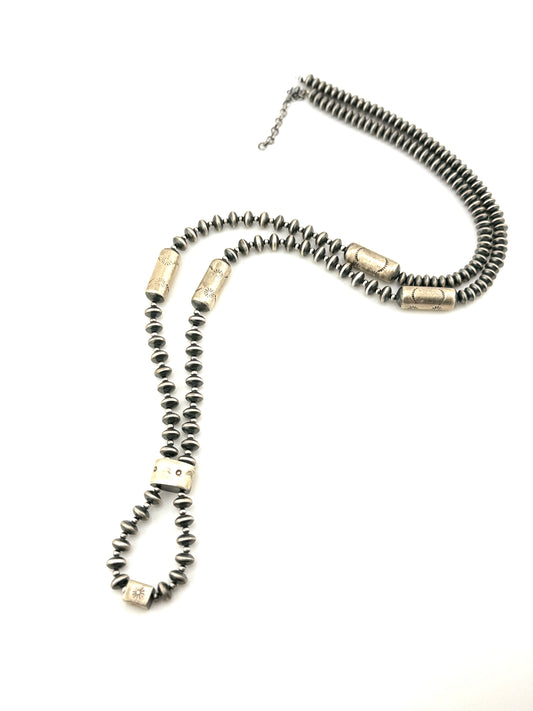 Necklace with cylindrical beads on a white background