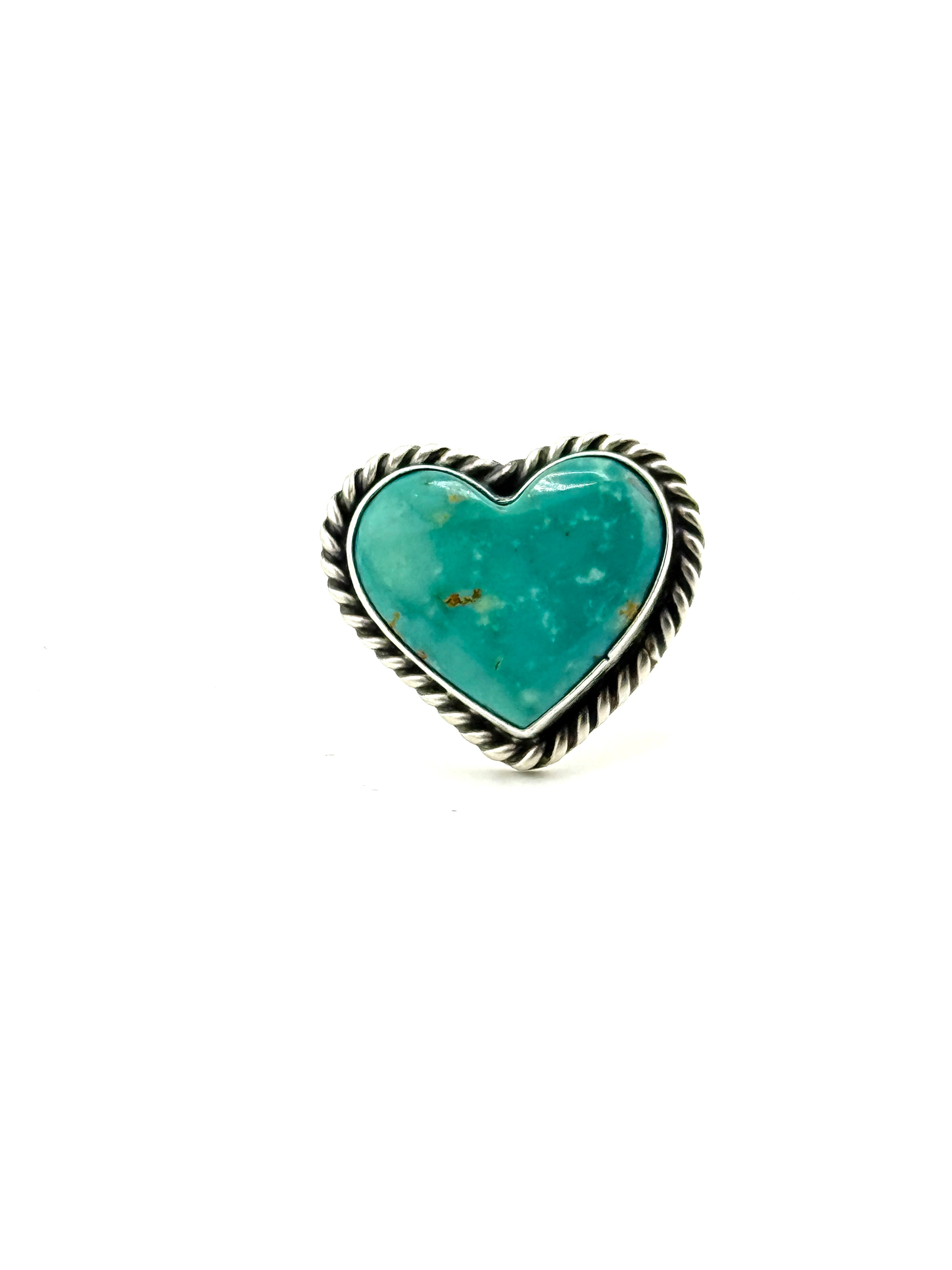 Turquoise heart-shaped stone with silver frame on a white background