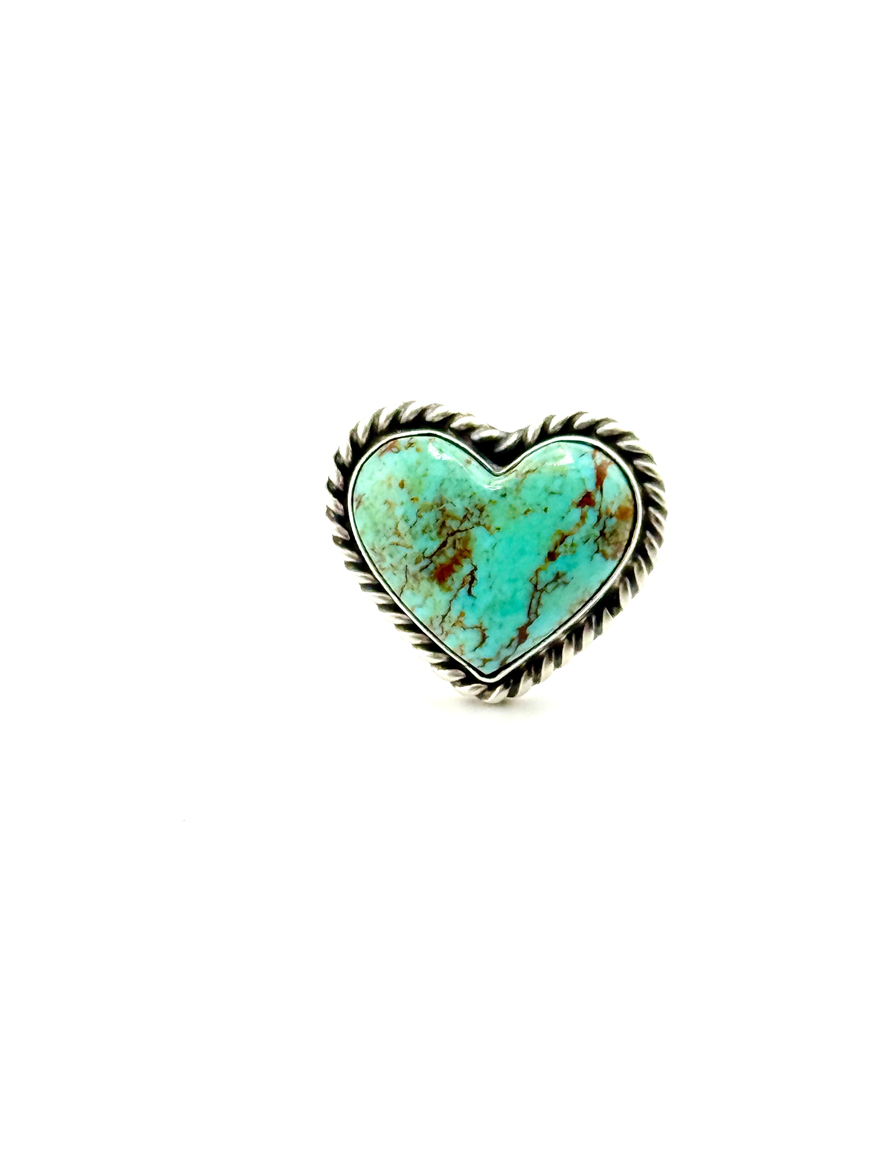 Turquoise heart-shaped stone with gold rim on a white background