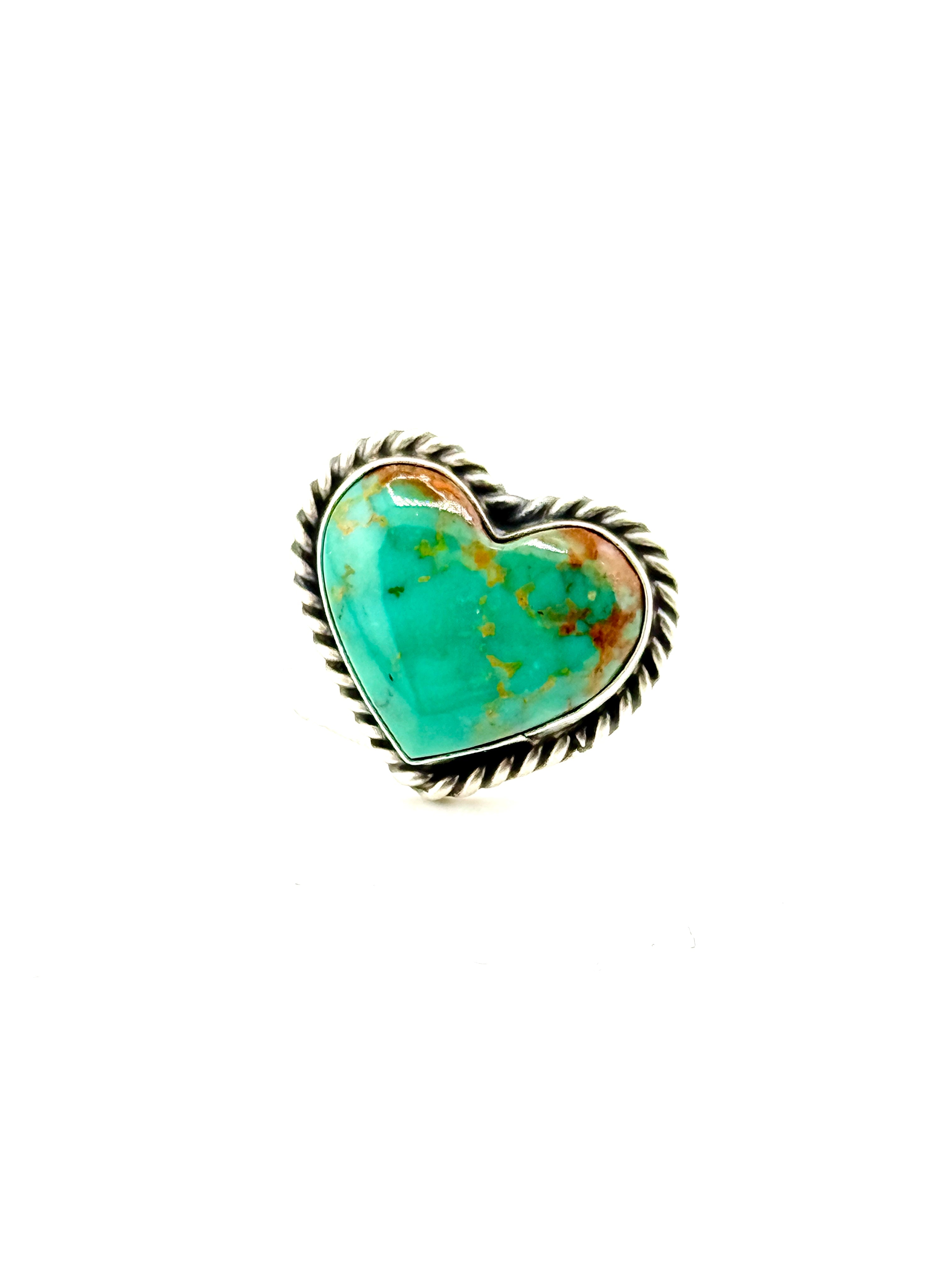 Heart-shaped turquoise stone ring with a silver band on a white background