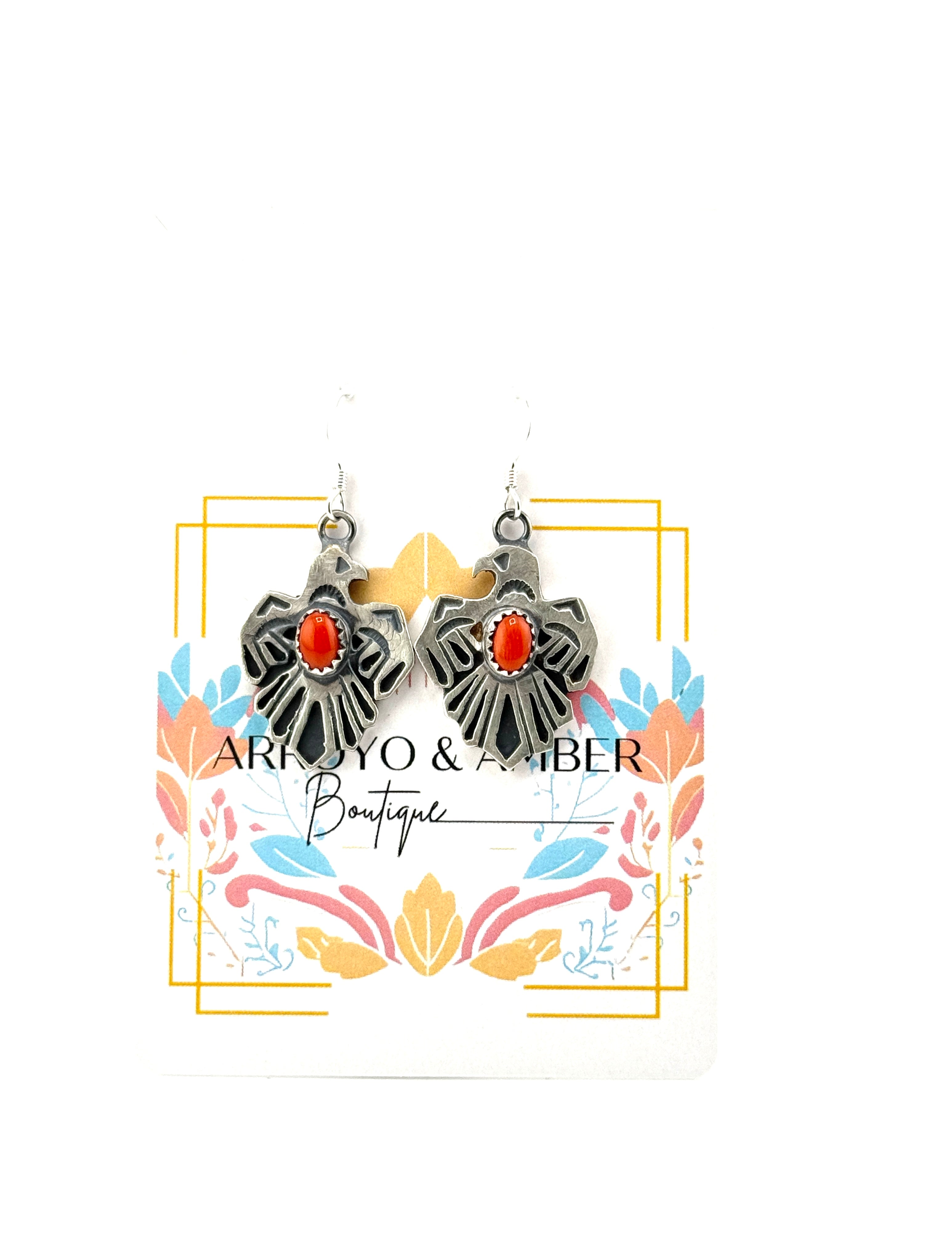 Silver thunderbird earrings with red coral stone