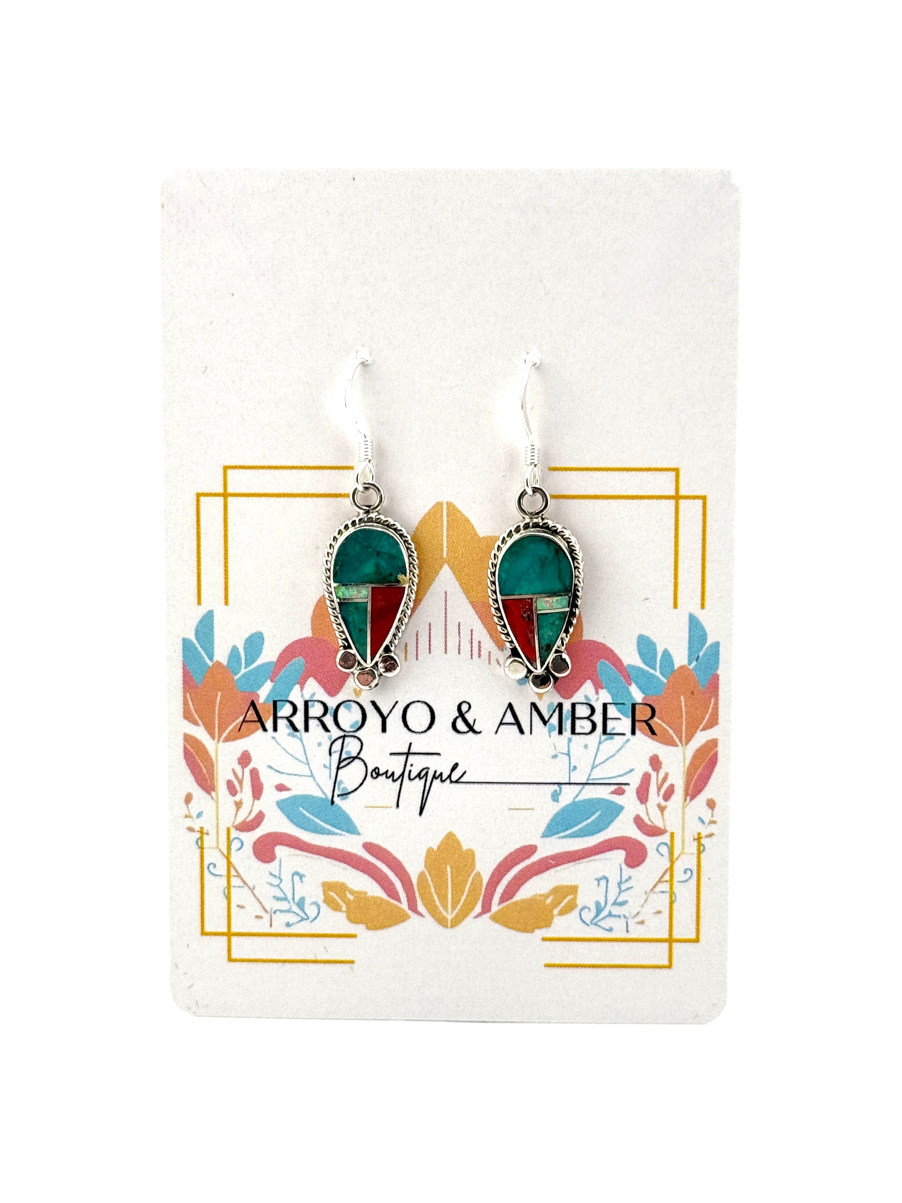 Pair of earrings on a 'Arroyo & Amber Boutique' card with decorative elements.
