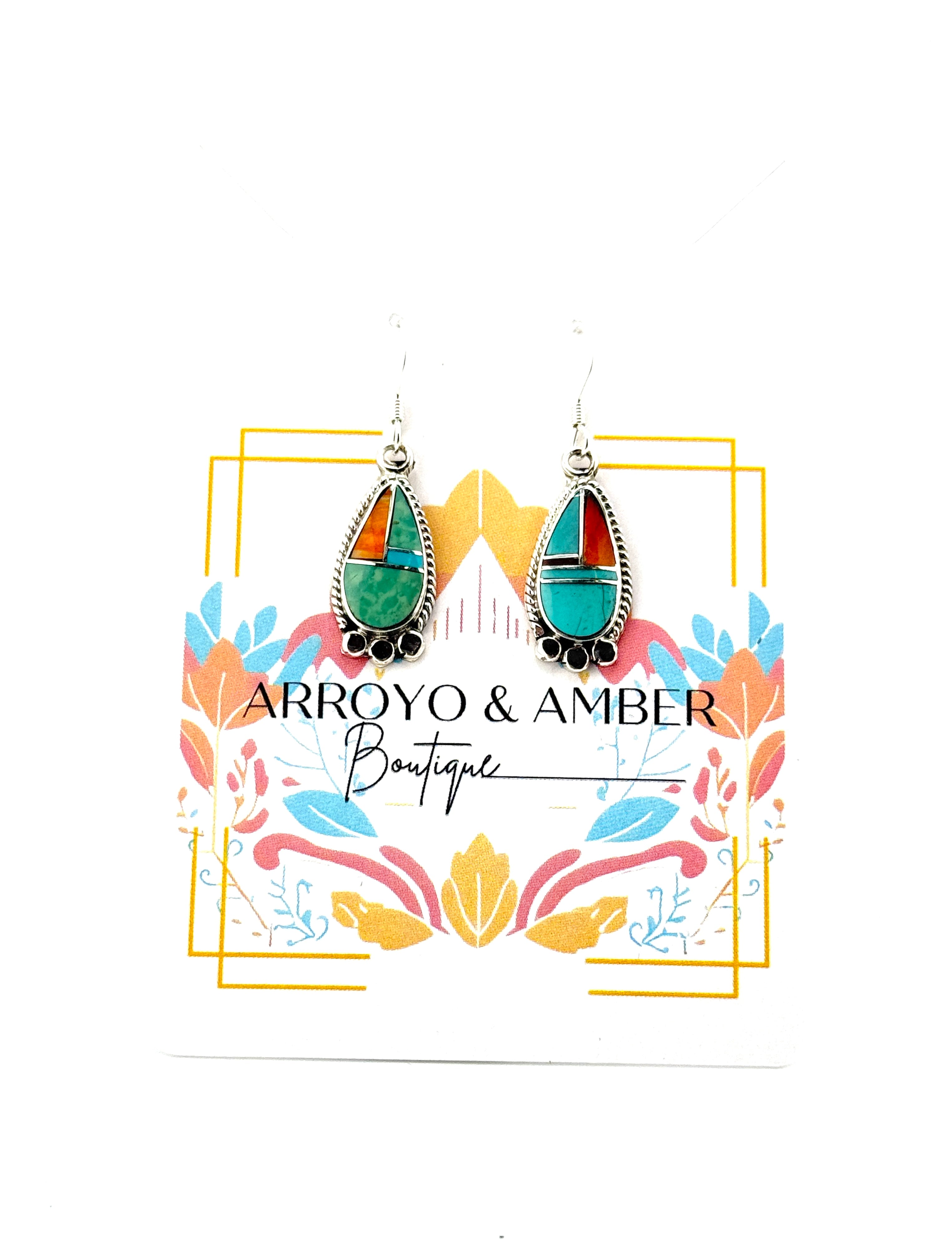 Earrings on a card with 'Arroyo & Amber Boutique' branding