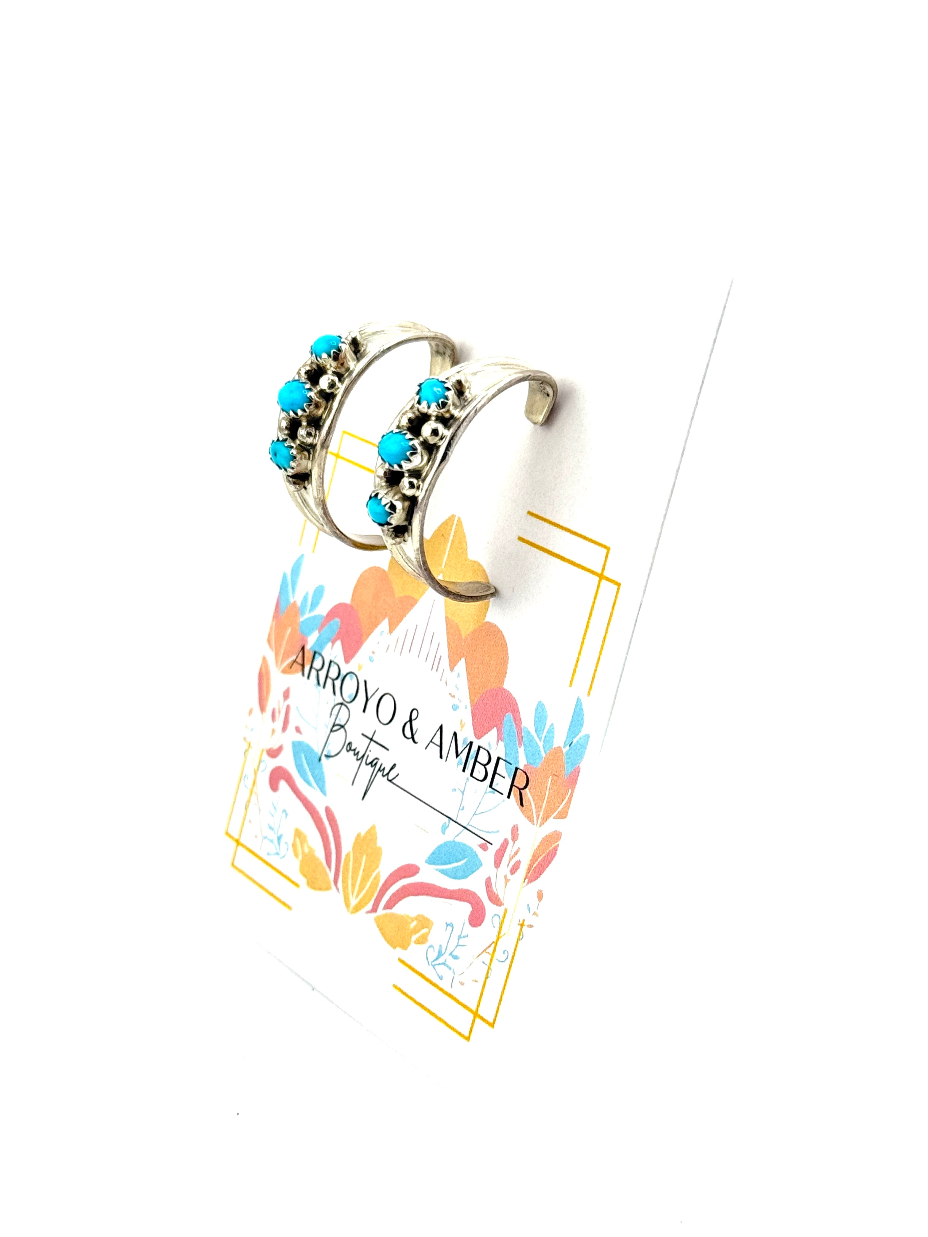 Earring on a branded card with 'Carrooy & Amber' design