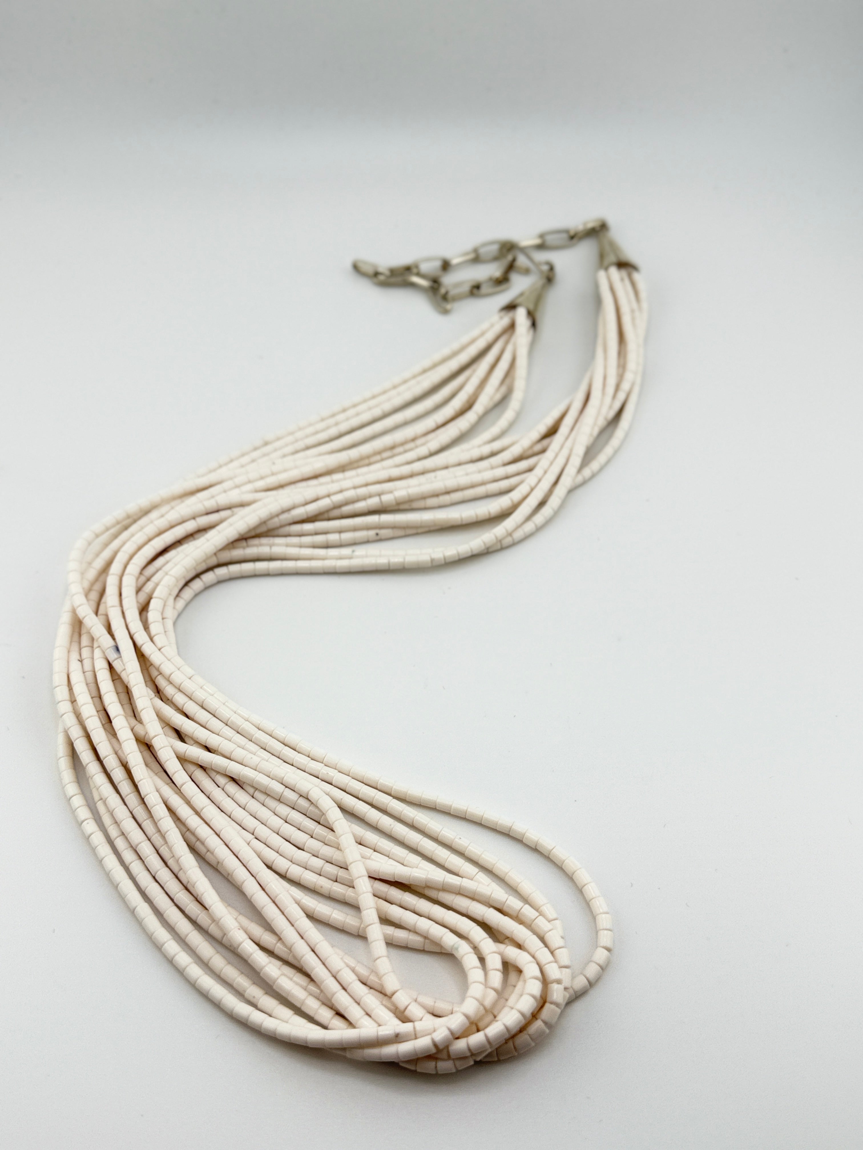 Necklace with multiple strands on a light gray background