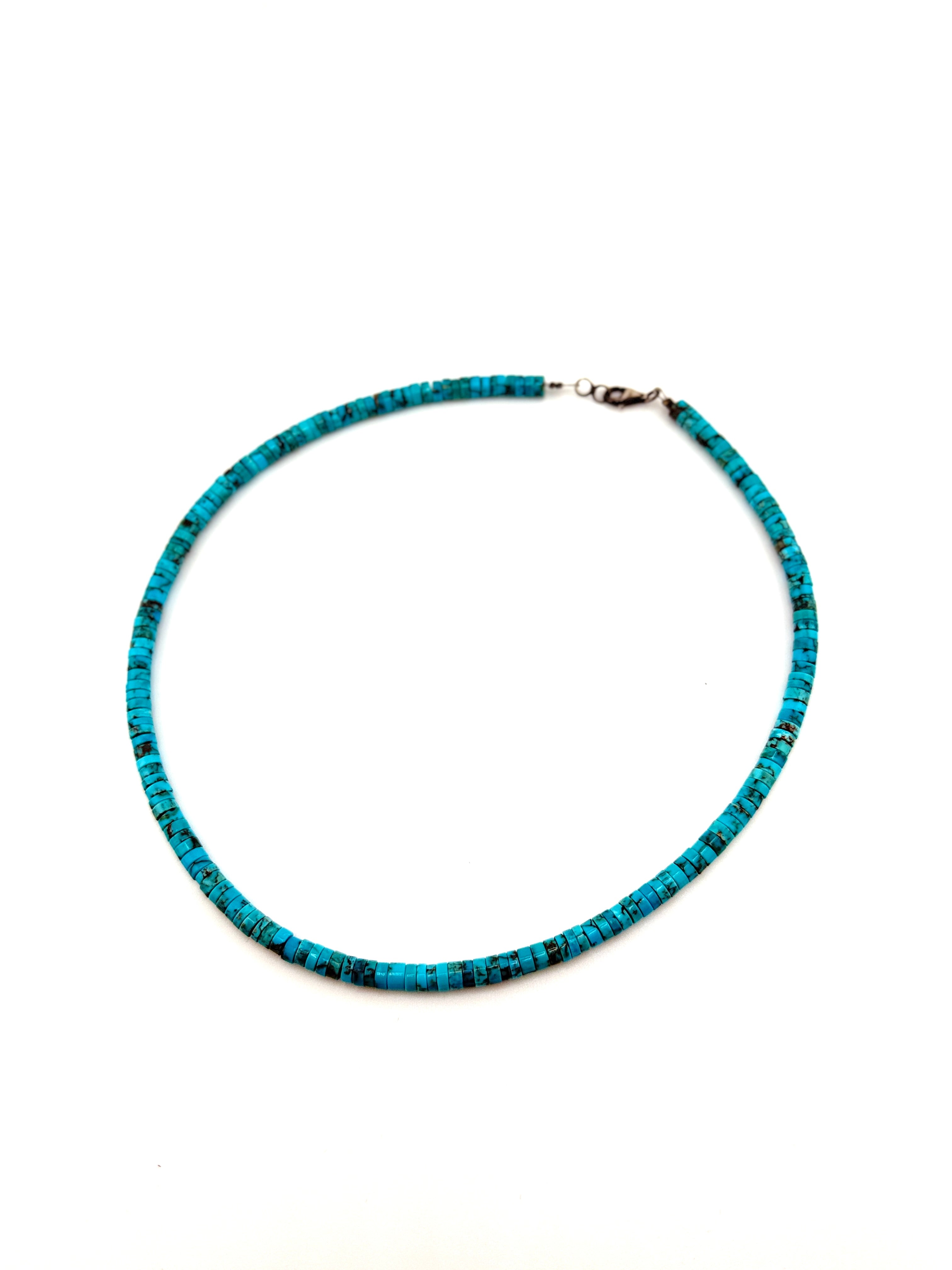 Turquoise beaded necklace on a white background