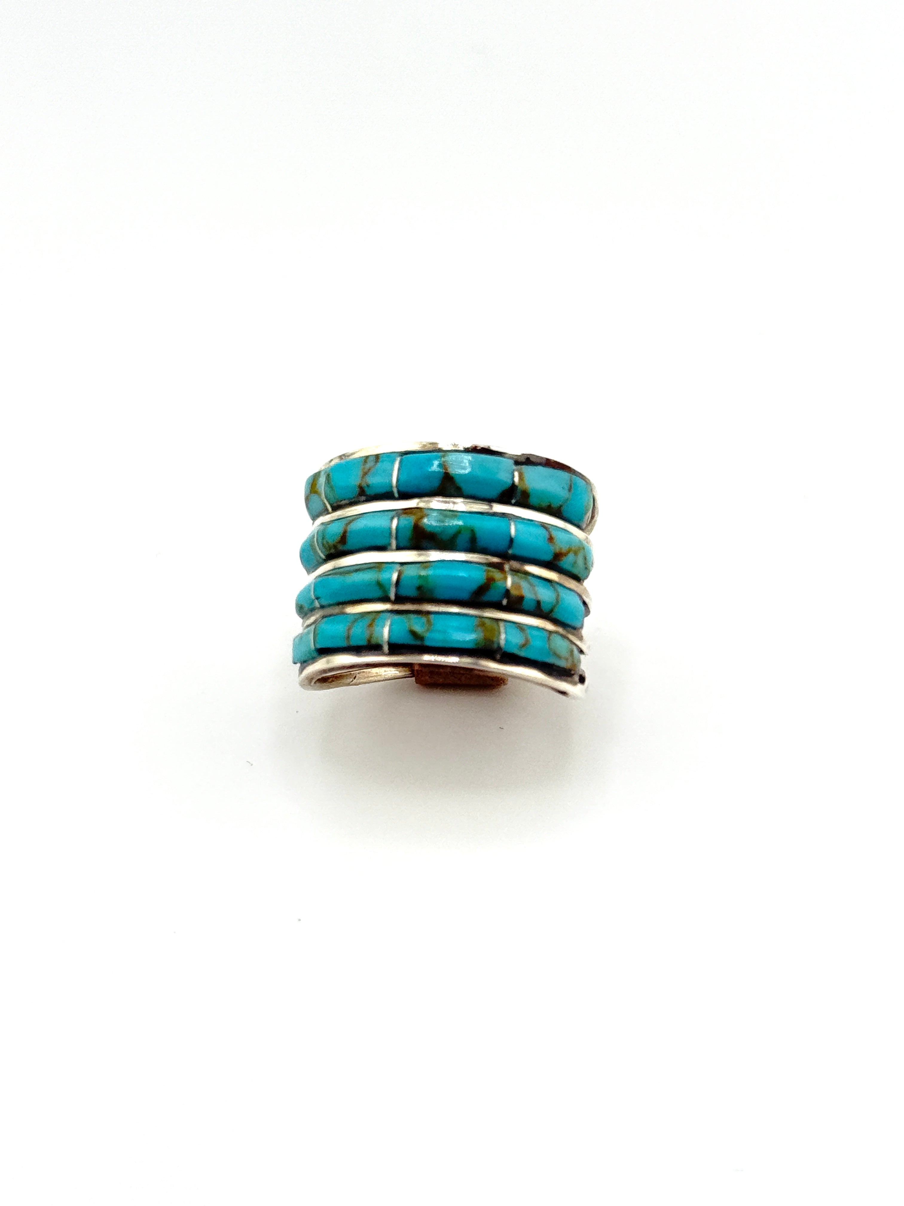 Turquoise ring with silver band on a white background