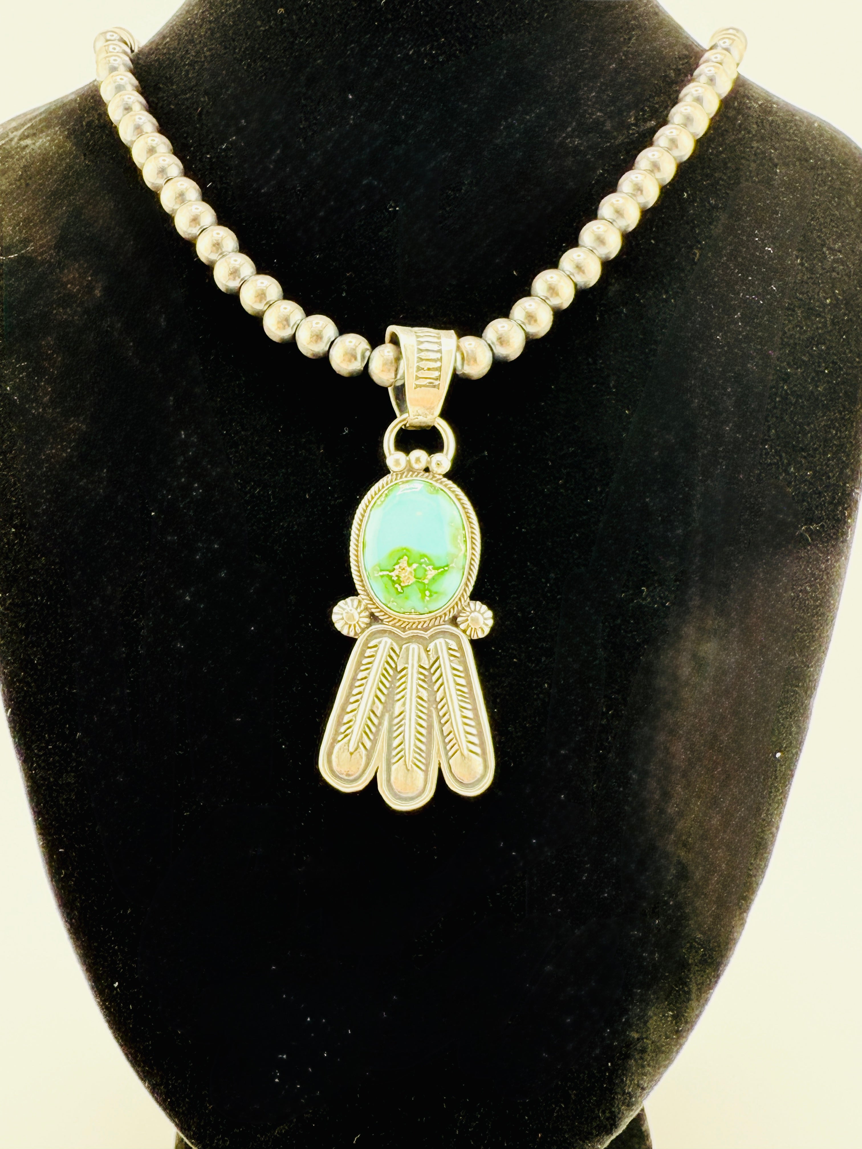 Necklace with a pendant on a black velvet stand