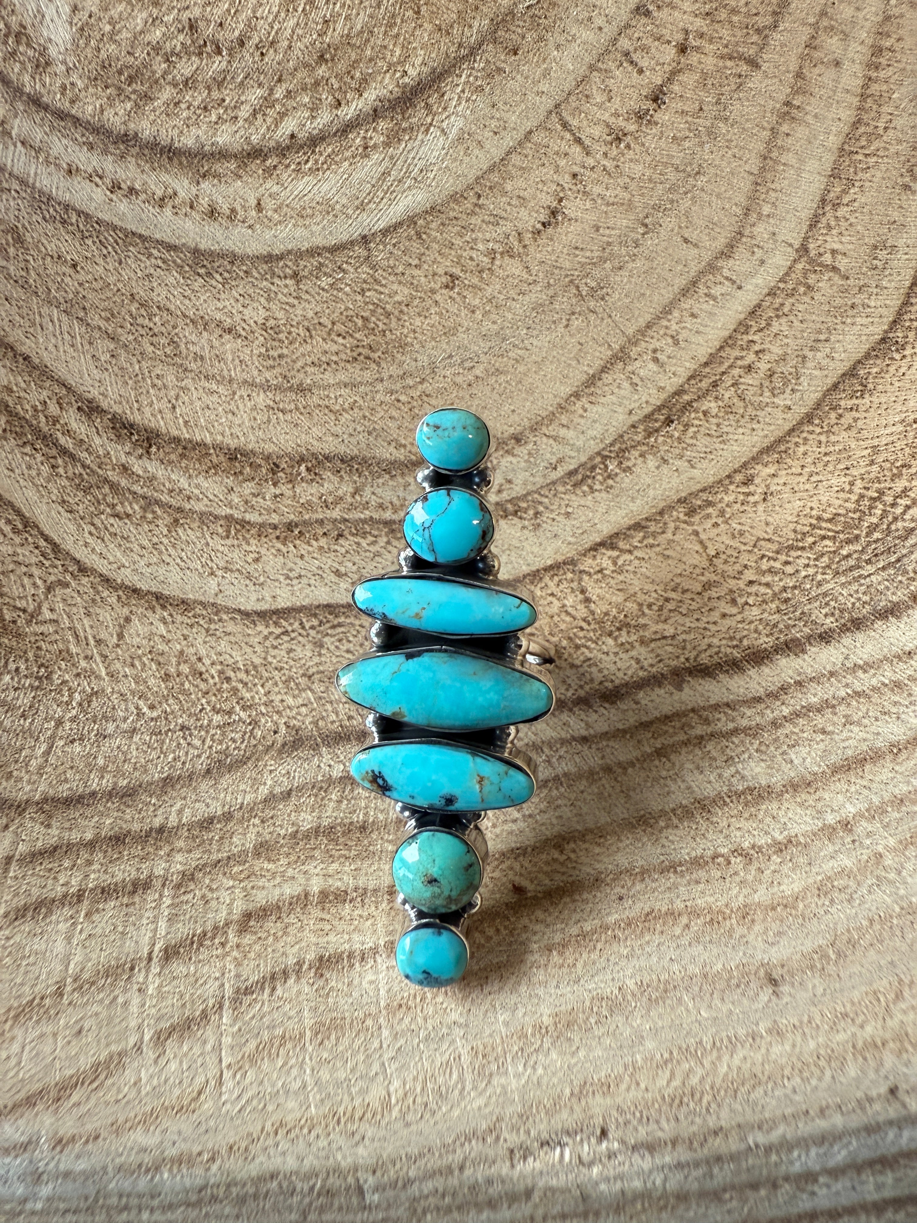 Turquoise stone necklace on a sandy background