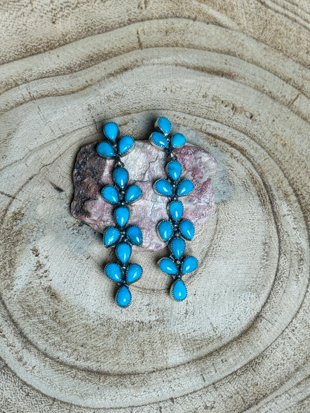 Turquoise earrings on a stone surface