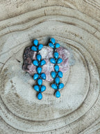 Turquoise earrings on a stone surface